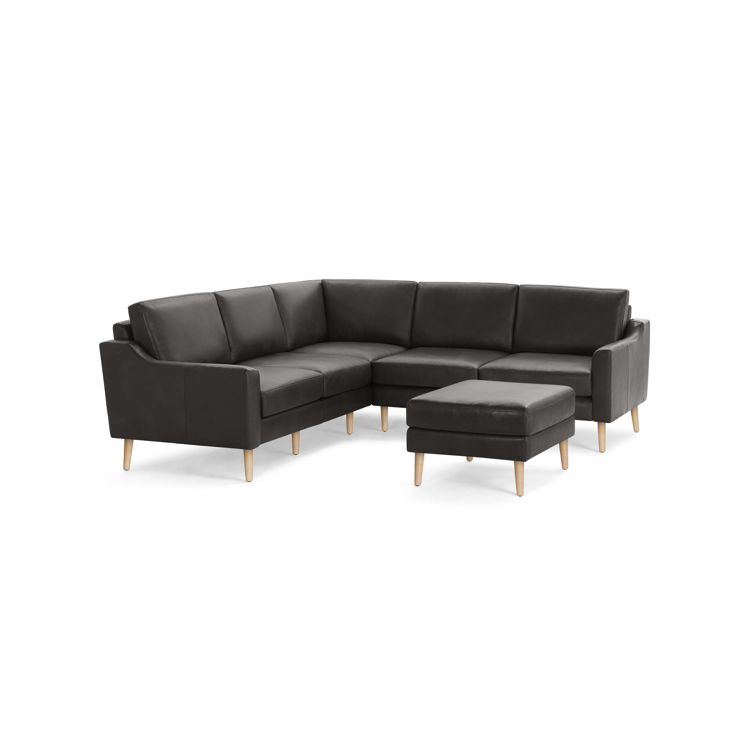 Dark gray leather sectional sofa with wooden tapered legs and matching ottoman, modern and comfortable design.