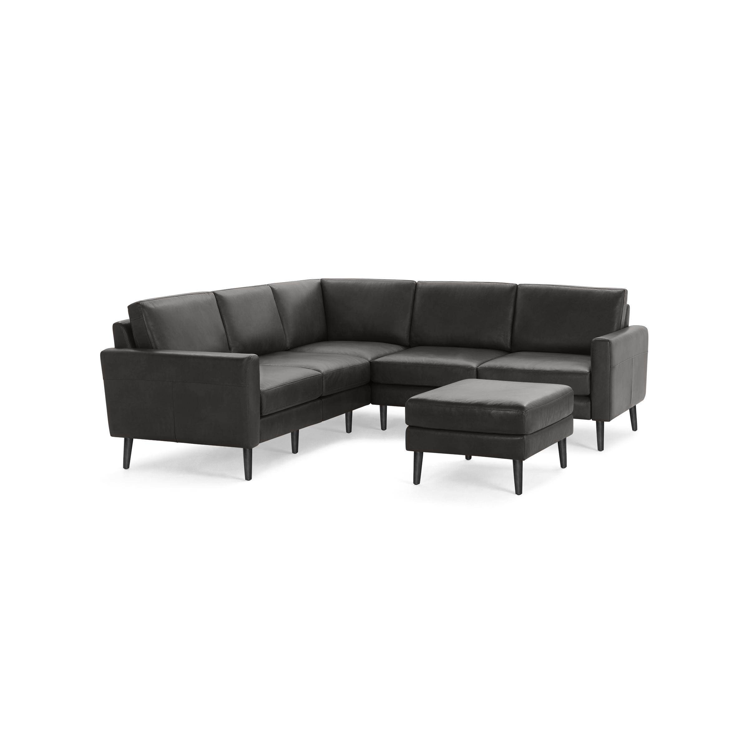Dark gray L-shaped sectional sofa with high back cushions and matching ottoman on wooden legs.