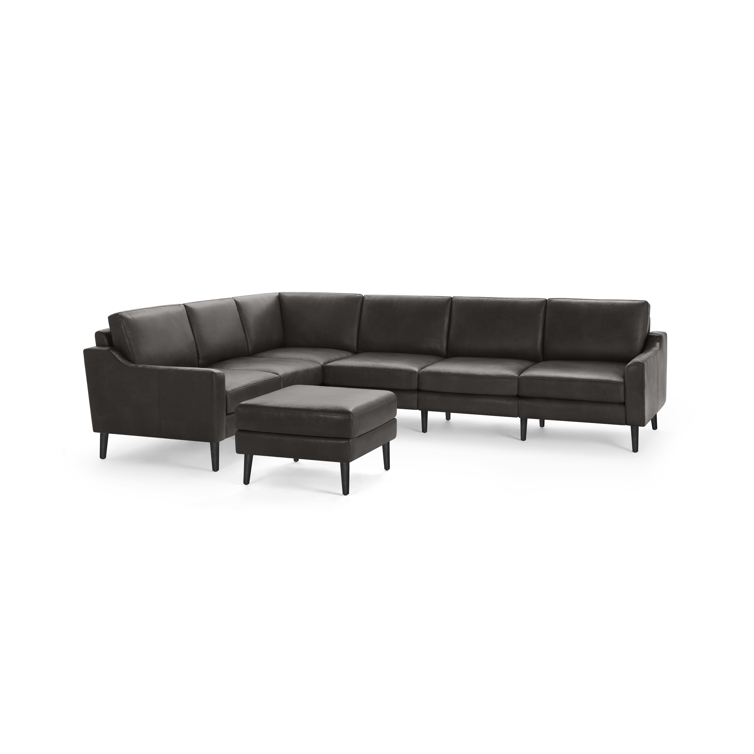 Dark gray leather sectional sofa with sleek arms and a matching cushioned ottoman on tapered legs.