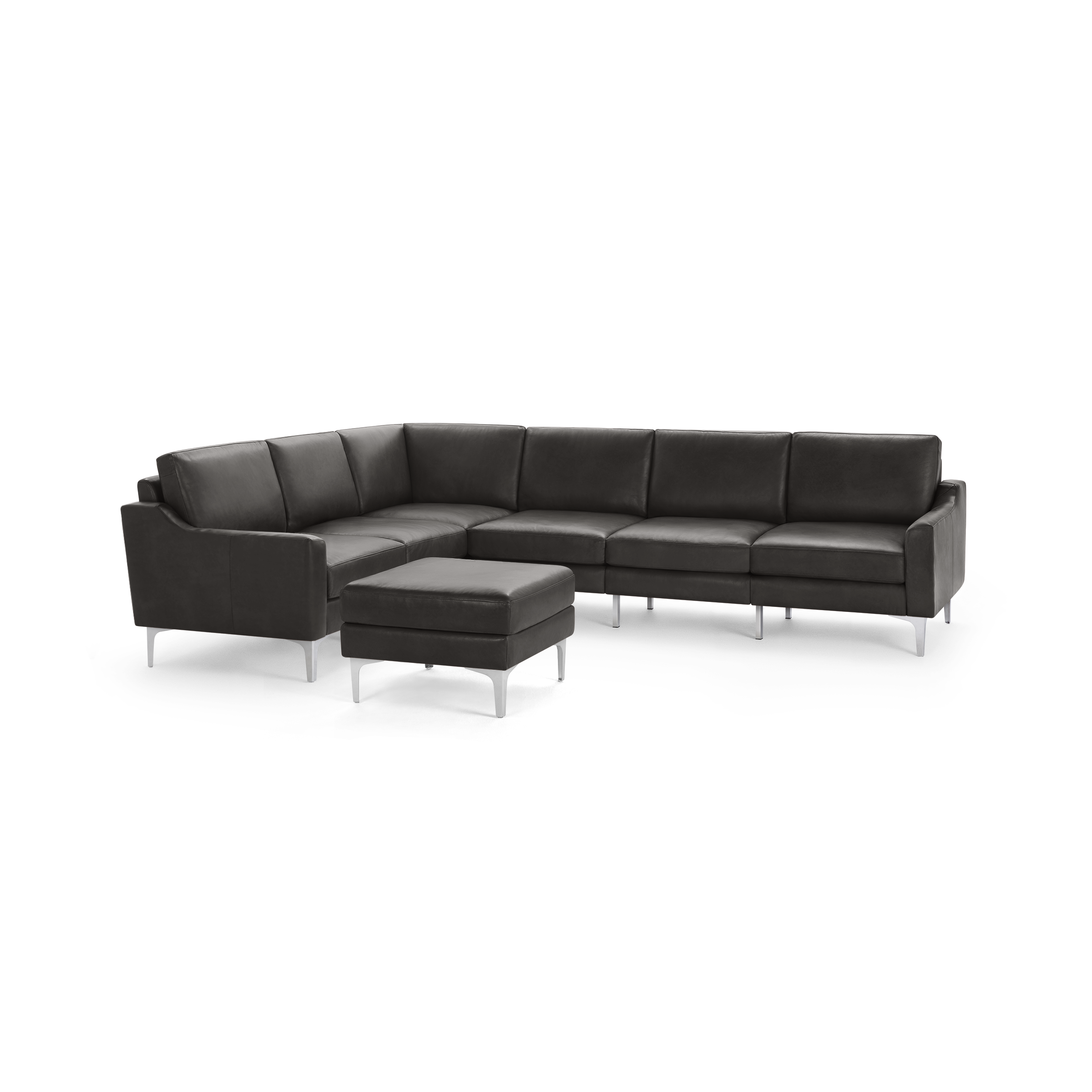 Dark gray leather sectional sofa with slim metal legs and matching ottoman, modern design and clean lines.