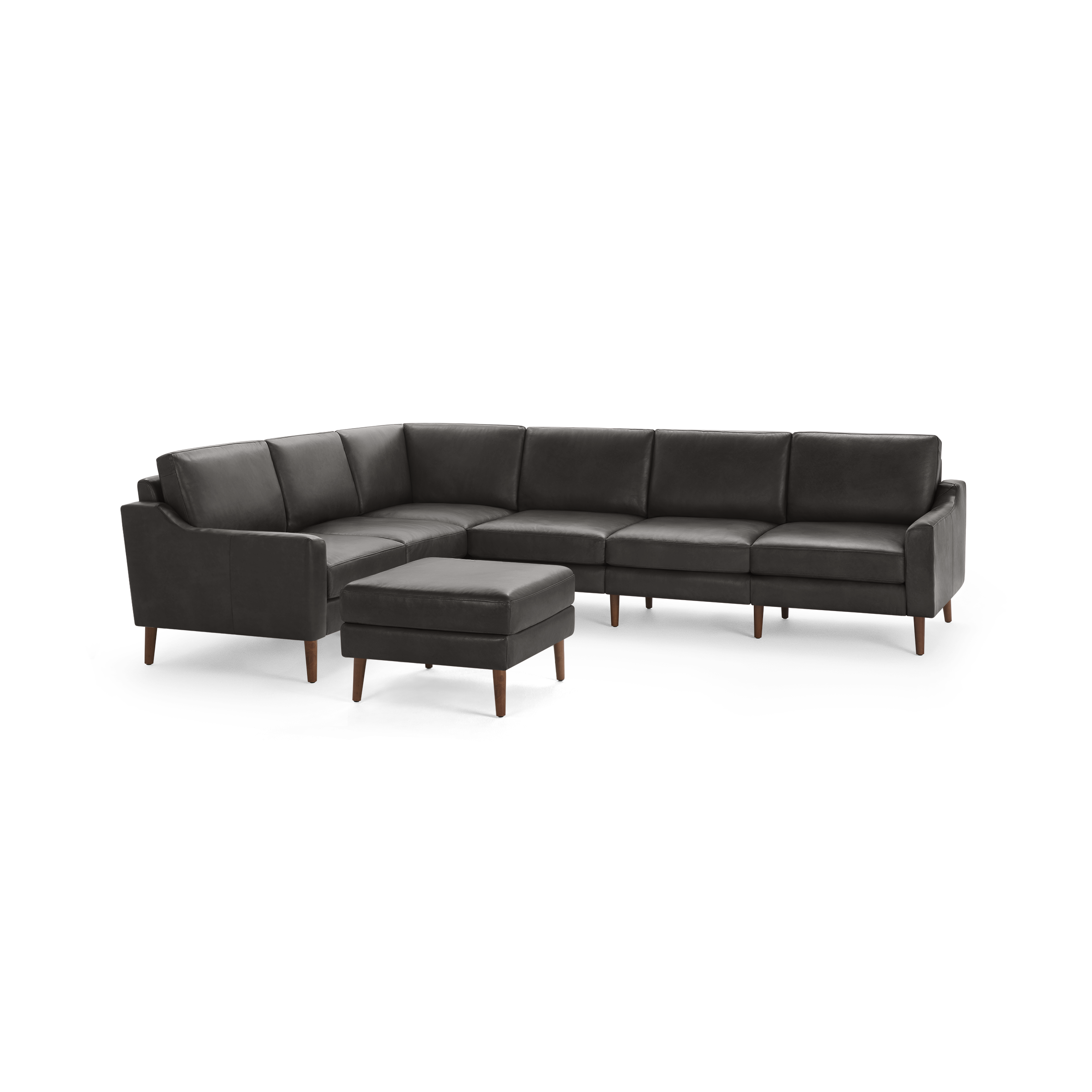 Dark gray leather sectional sofa with wooden legs and matching ottoman, featuring clean lines and modern design.