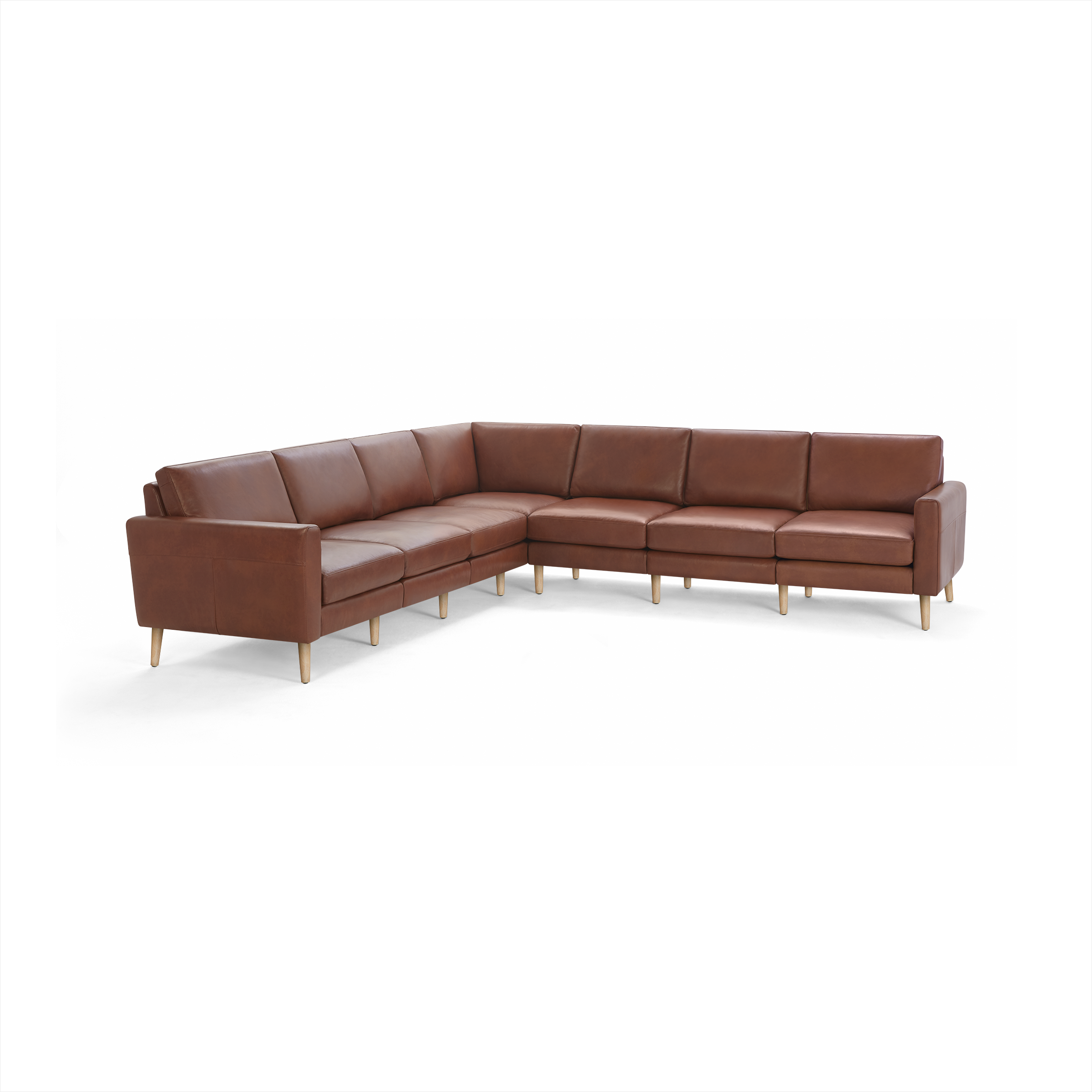 Large L-shaped sectional sofa with brown leather upholstery and light wooden legs, featuring clean lines and cushioned seats and backs.