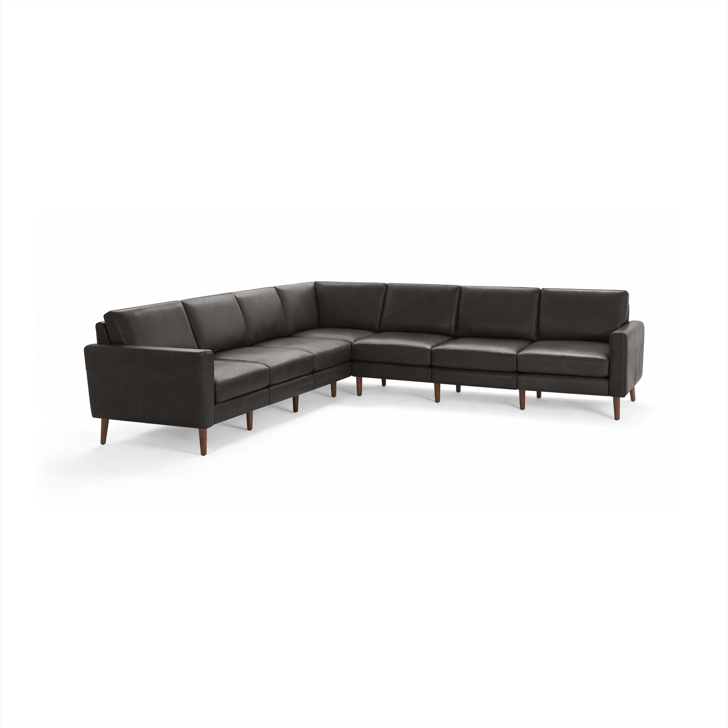 Large black leather sectional sofa with wooden legs, featuring a modern design and cushioned seats and backrests.