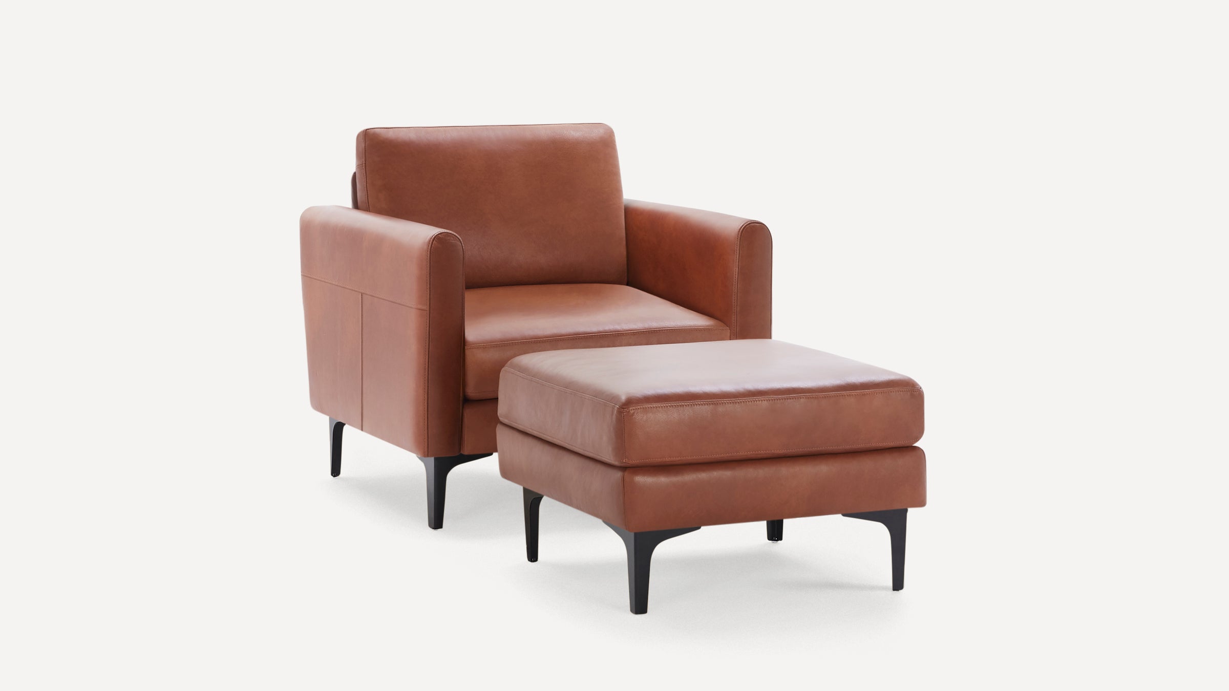 Brown leather armchair with matching ottoman, featuring sleek black tapered legs and modern design.
