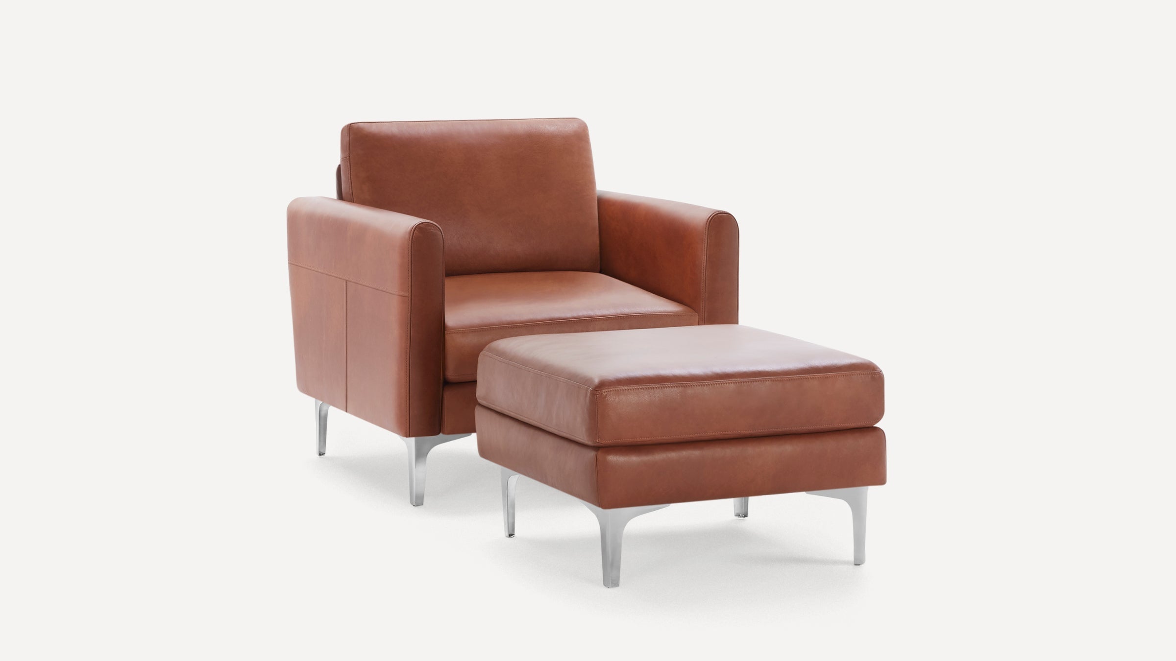 Modern brown leather armchair with matching ottoman, featuring sleek silver metal legs on a white background.