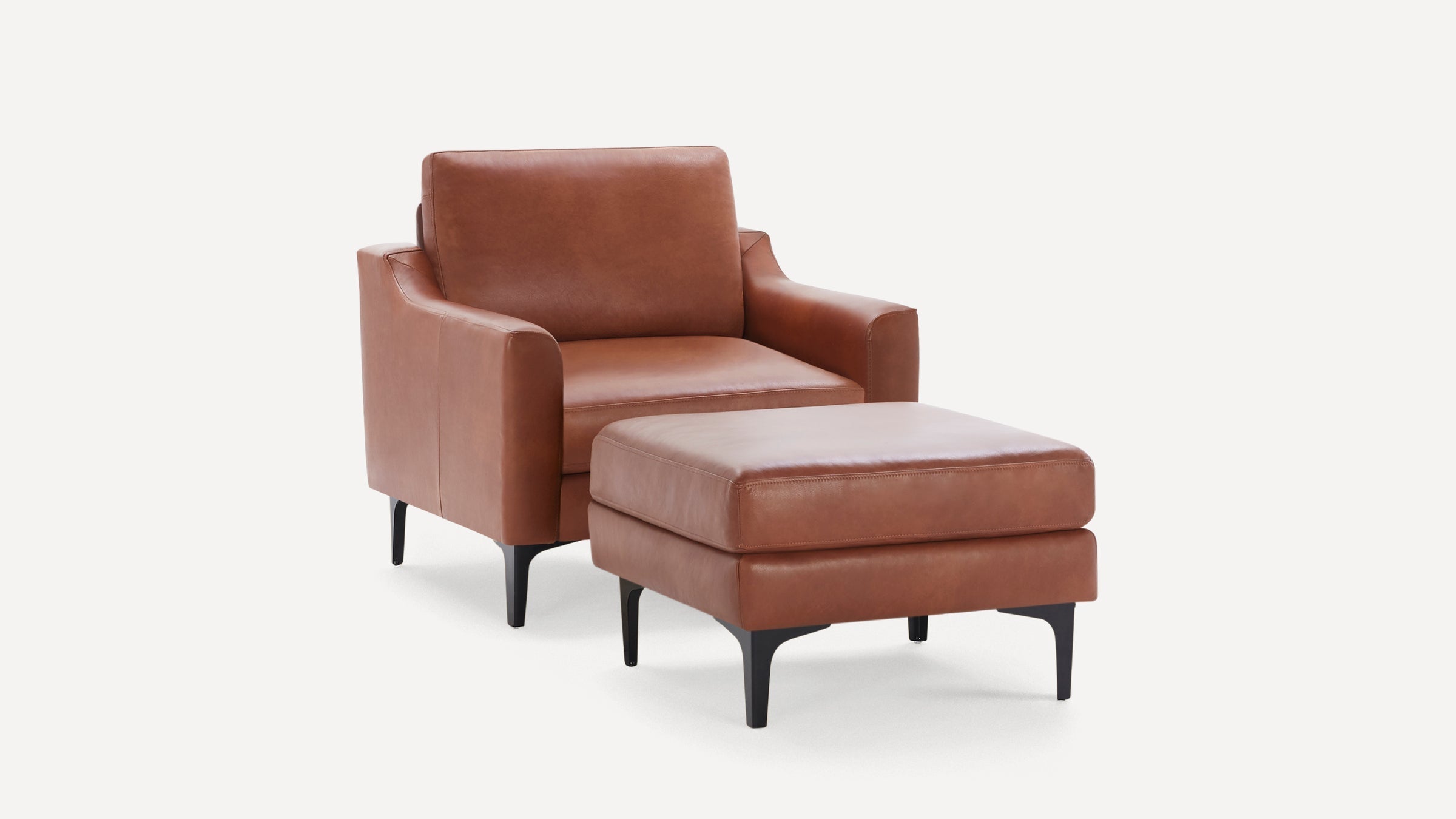 Brown leather armchair with matching ottoman, featuring sleek black legs and modern, clean lines.