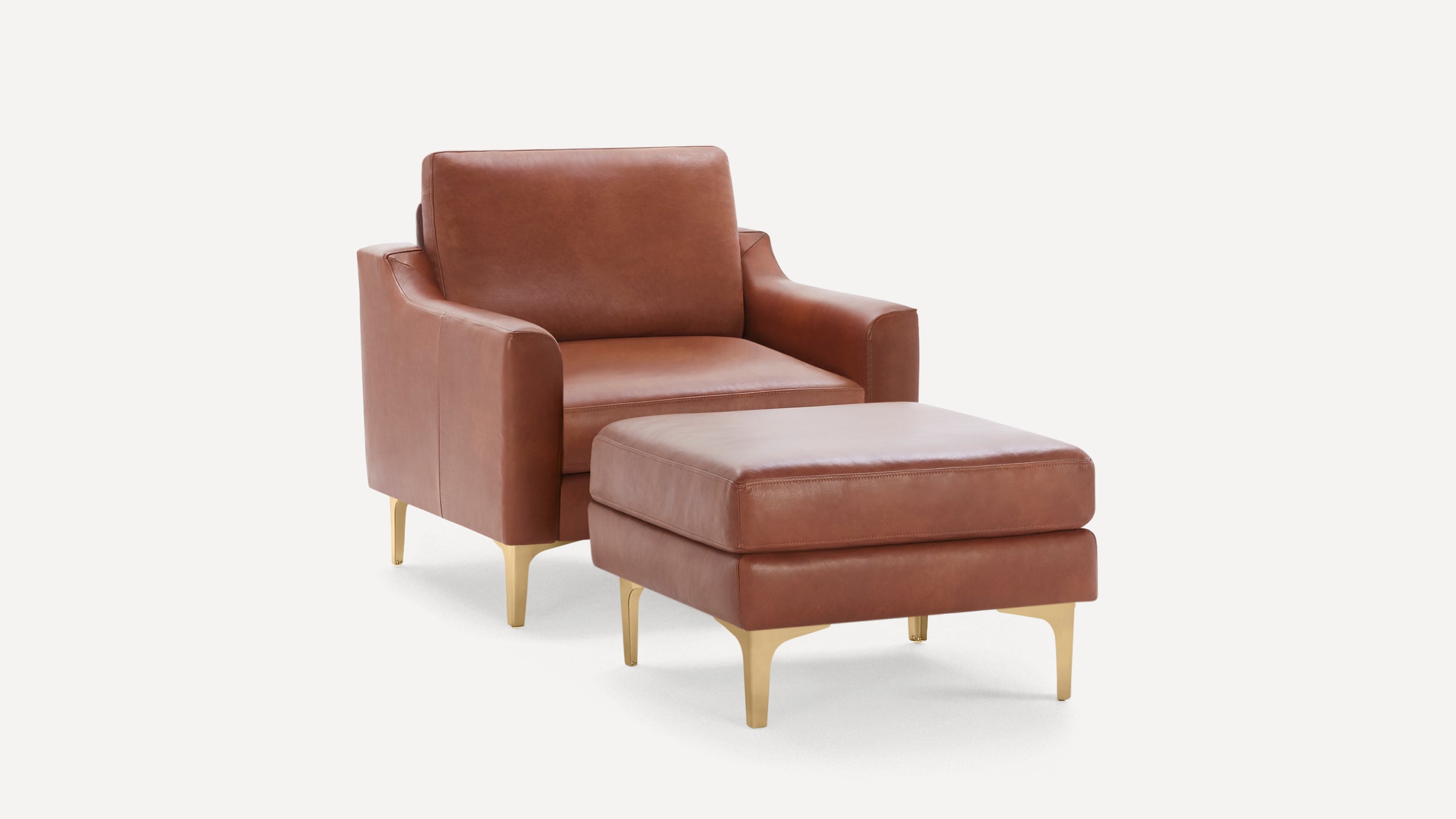 Modern brown leather armchair with matching ottoman, both featuring sleek gold metal legs and minimalist design.