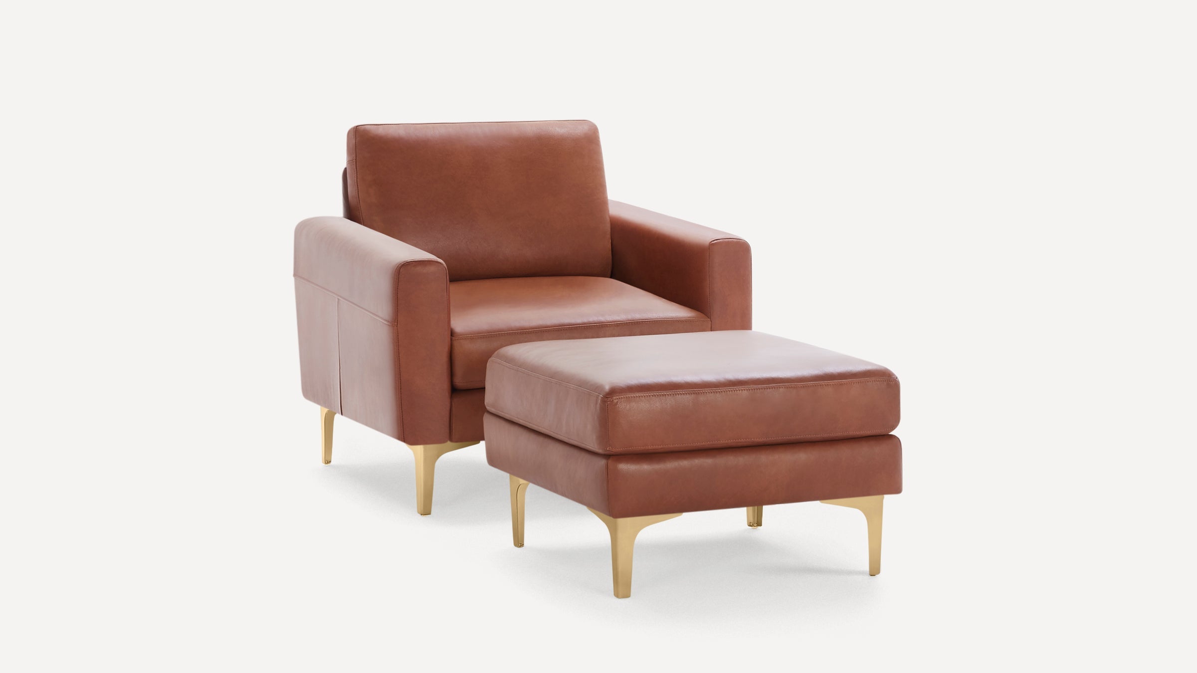 Modern brown leather armchair with matching ottoman, both featuring sleek gold metal legs on a plain white background.