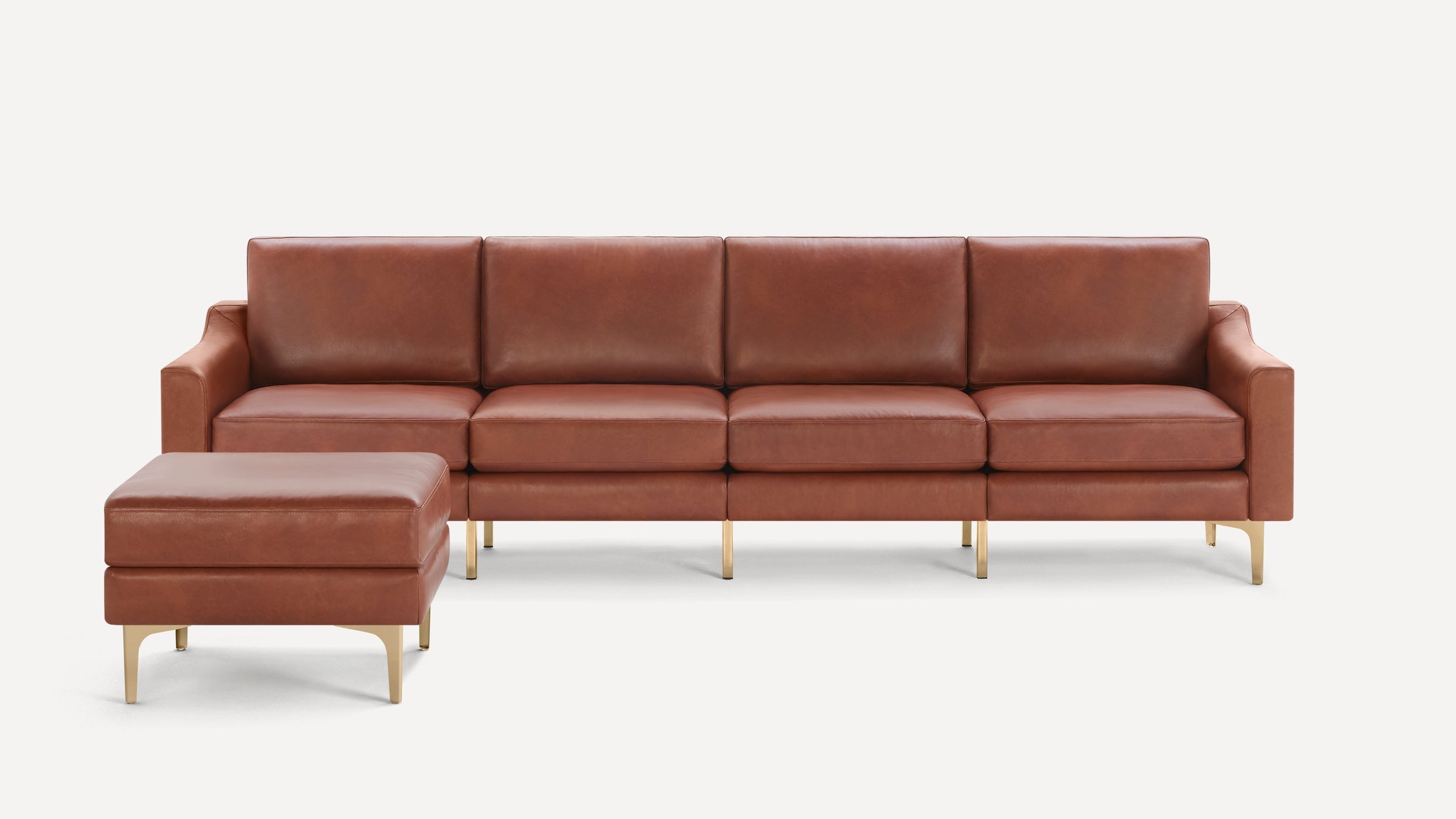 Modern brown leather sectional sofa with matching ottoman and gold metal legs on white background.