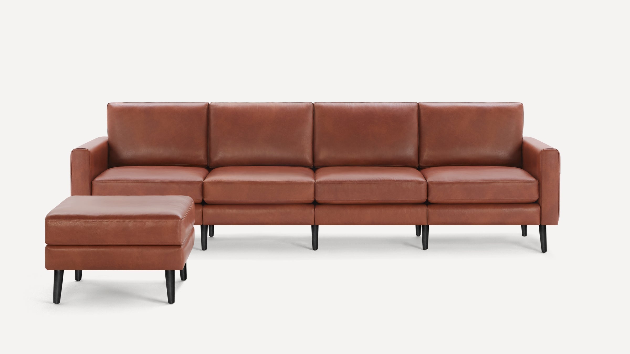 Modern brown leather sectional sofa with matching ottoman, featuring clean lines and black tapered legs, on white background.