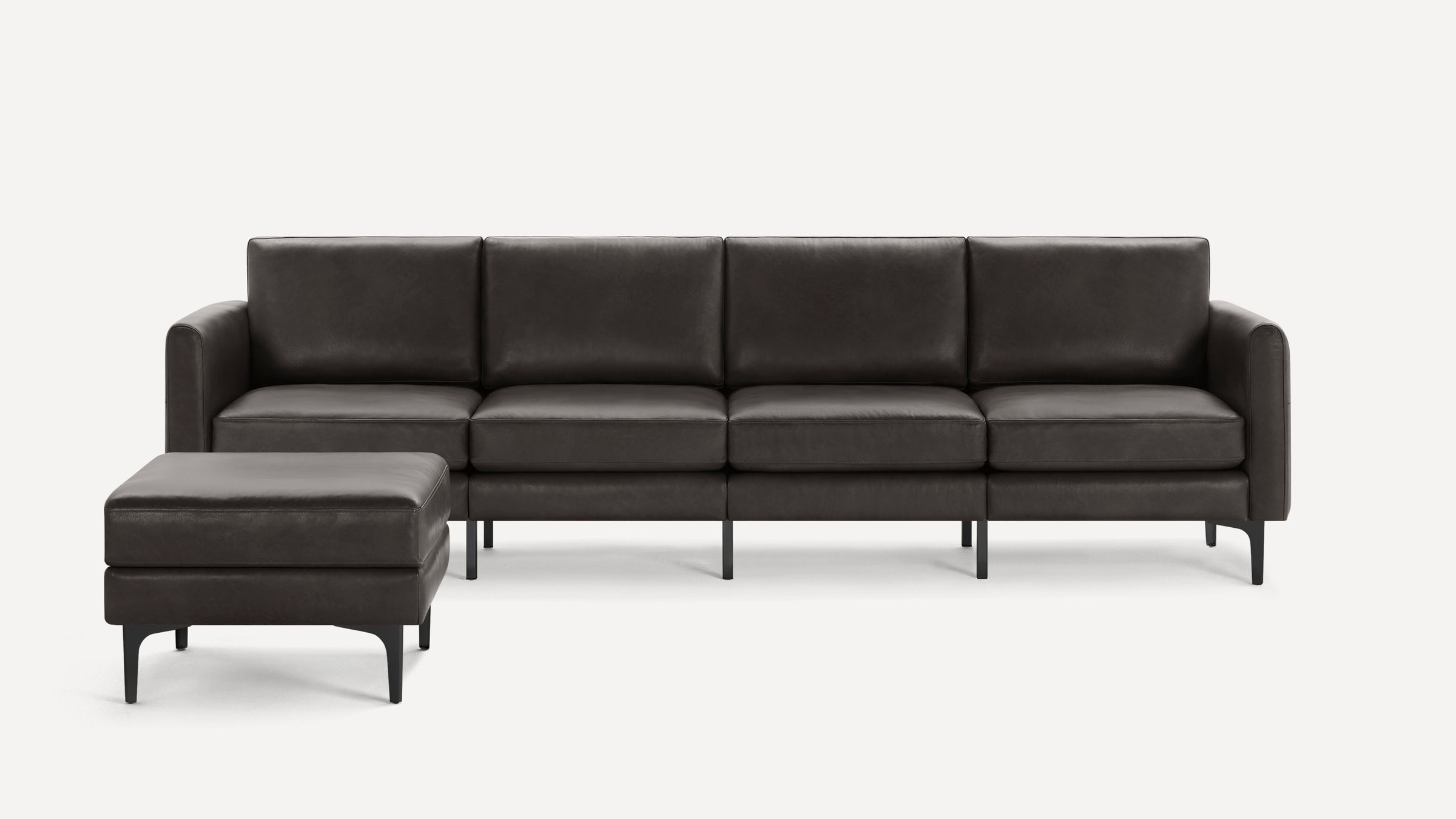 Dark brown leather sectional sofa with clean lines and matching ottoman on slender black legs.