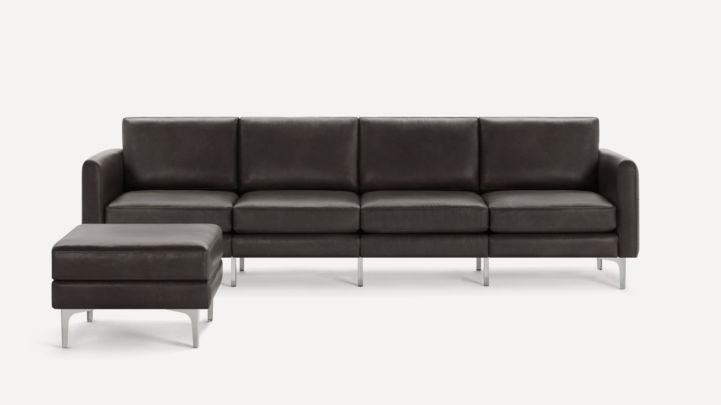 Modern dark brown leather sectional sofa with metal legs, featuring a chaise lounge ottoman on left side.