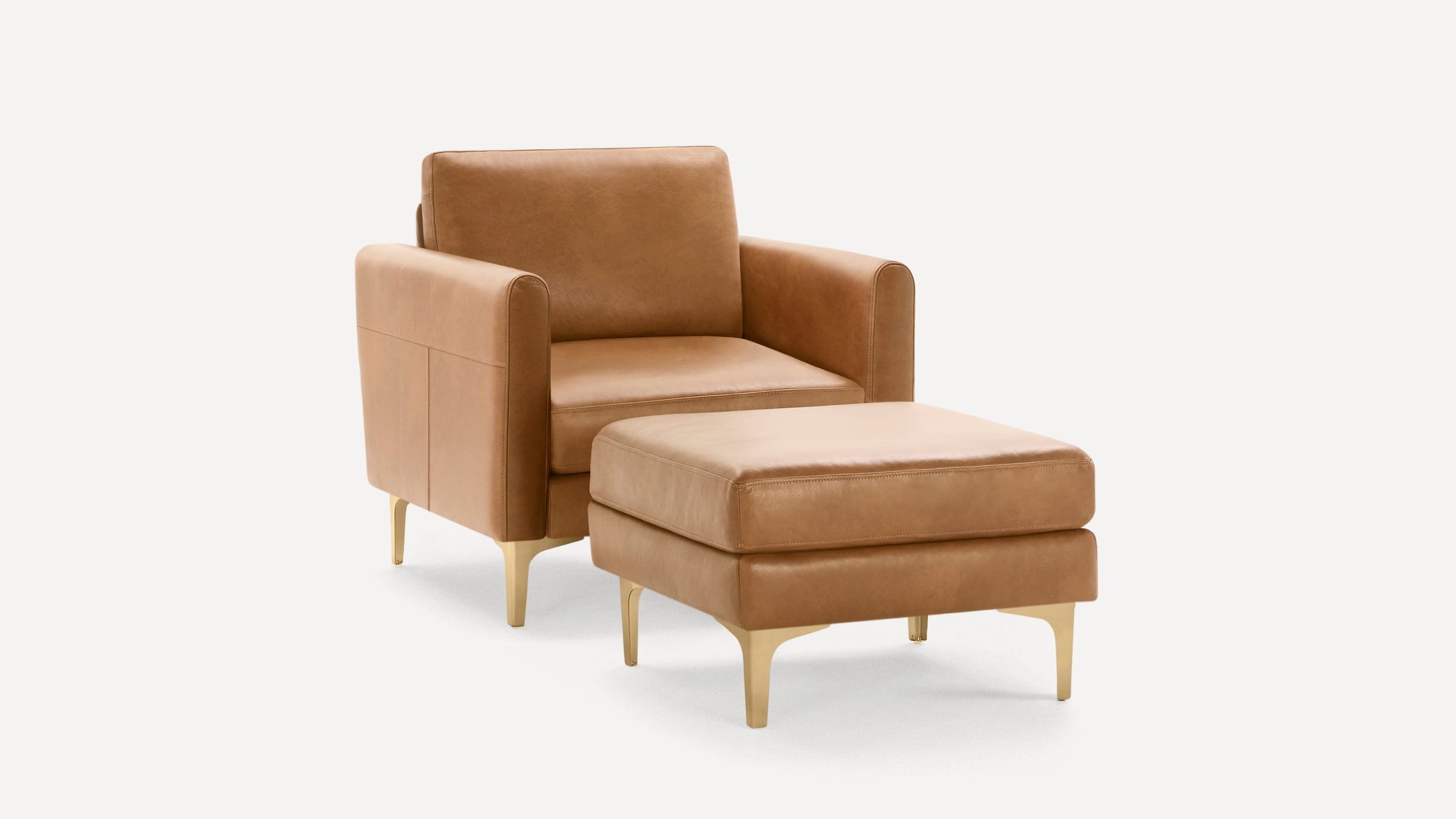 Modern tan leather armchair with matching ottoman, featuring sleek gold legs and clean, square design.