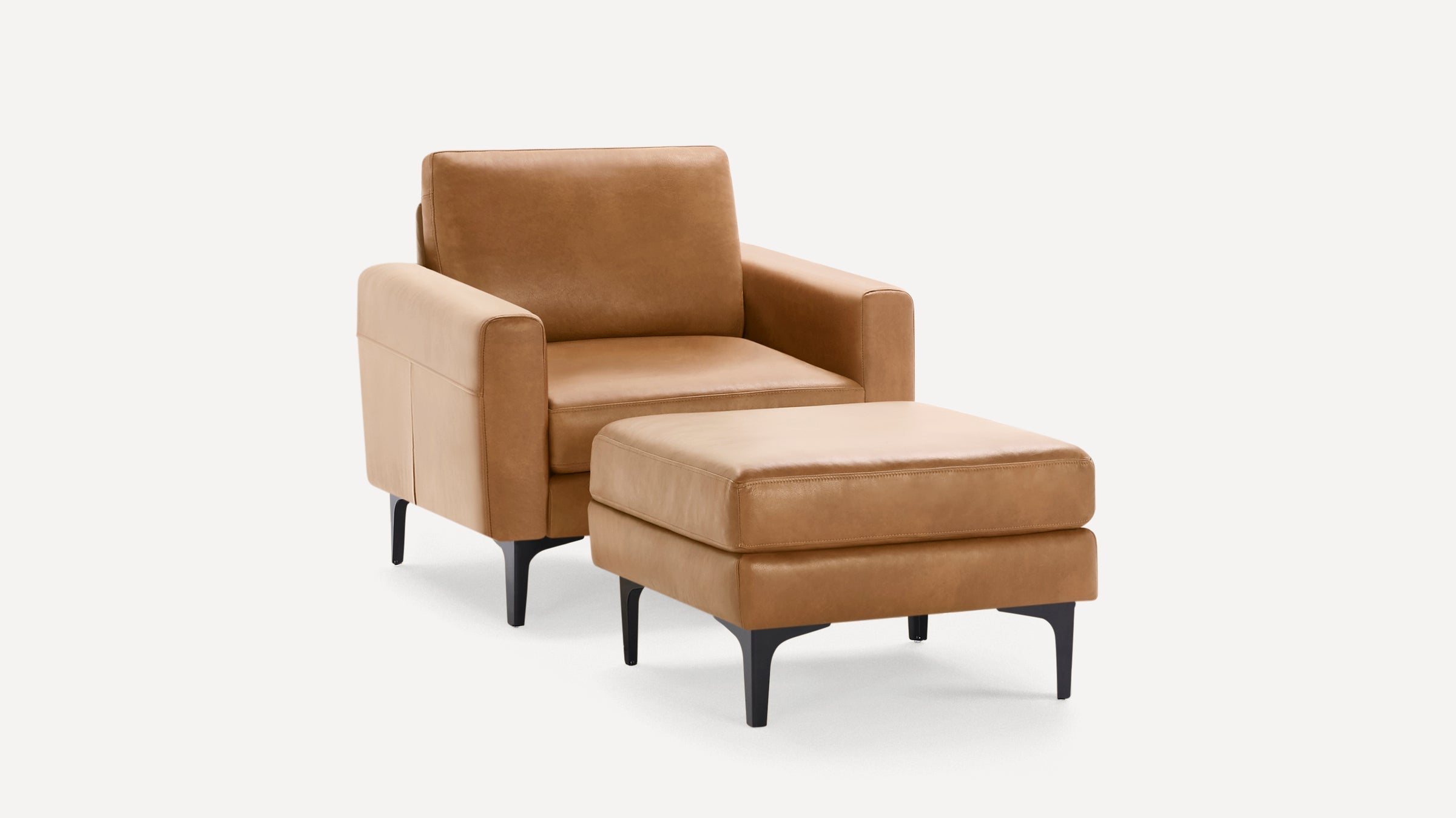 Modern tan leather armchair with matching ottoman, featuring black legs and clean, minimalist design.