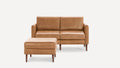 Light brown leather loveseat sofa with square arms paired with matching cushioned ottoman, both featuring tapered wooden legs.