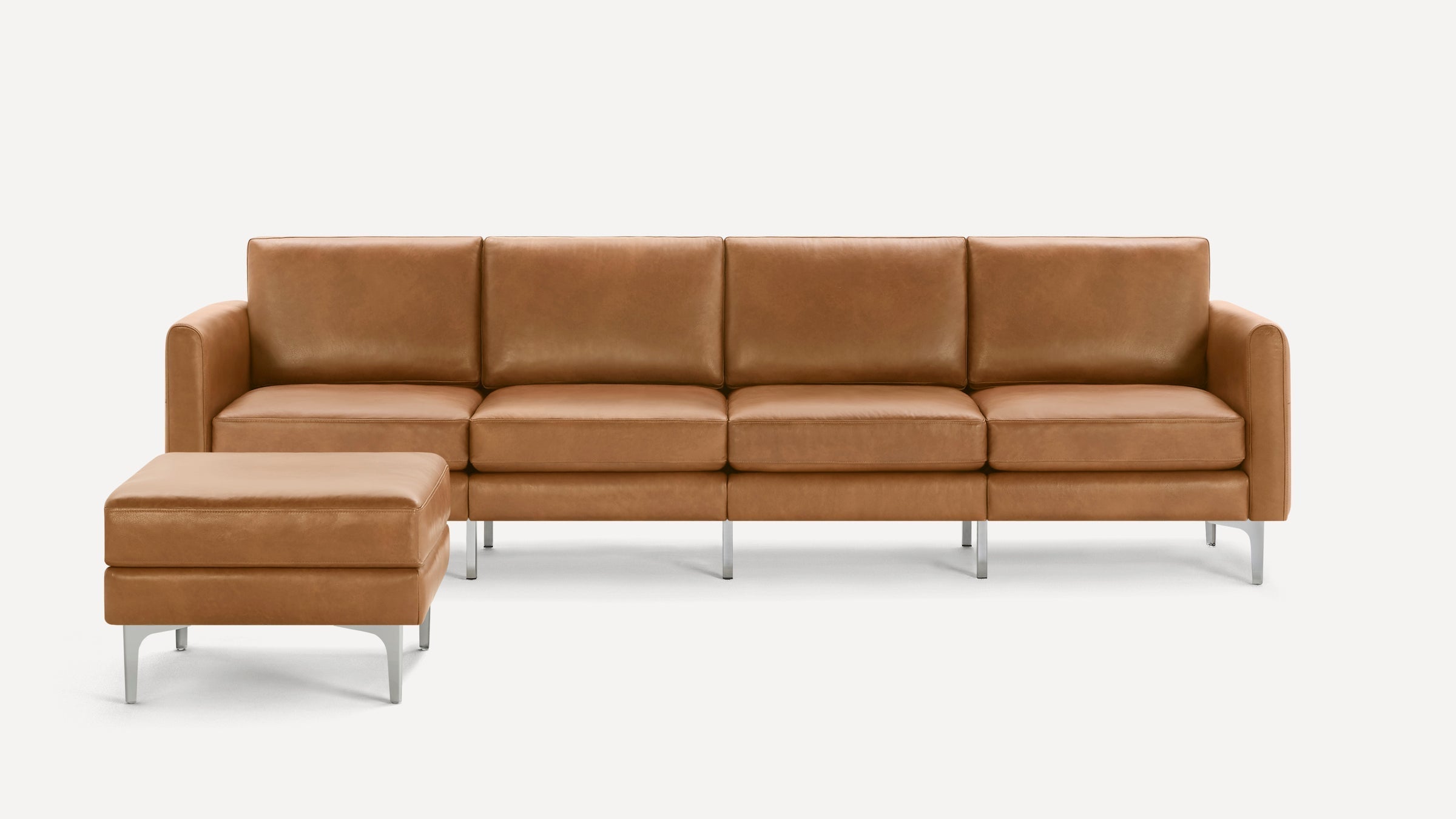 Modern brown leather sectional sofa with four seat cushions and a matching ottoman, supported by sleek silver metal legs.