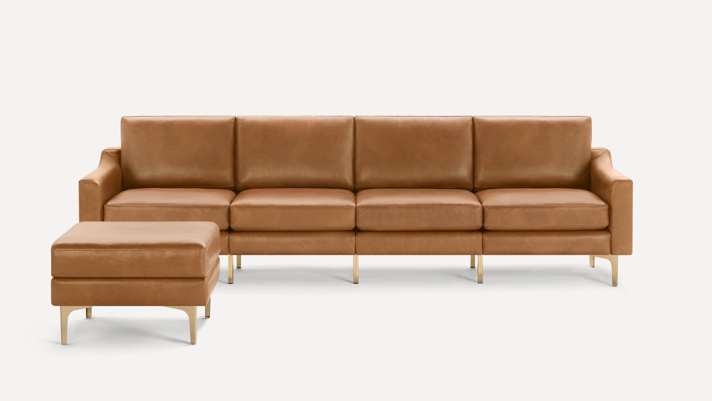 Modern tan leather sectional sofa with clean lines, square cushions, and gold metal legs, including a matching ottoman.