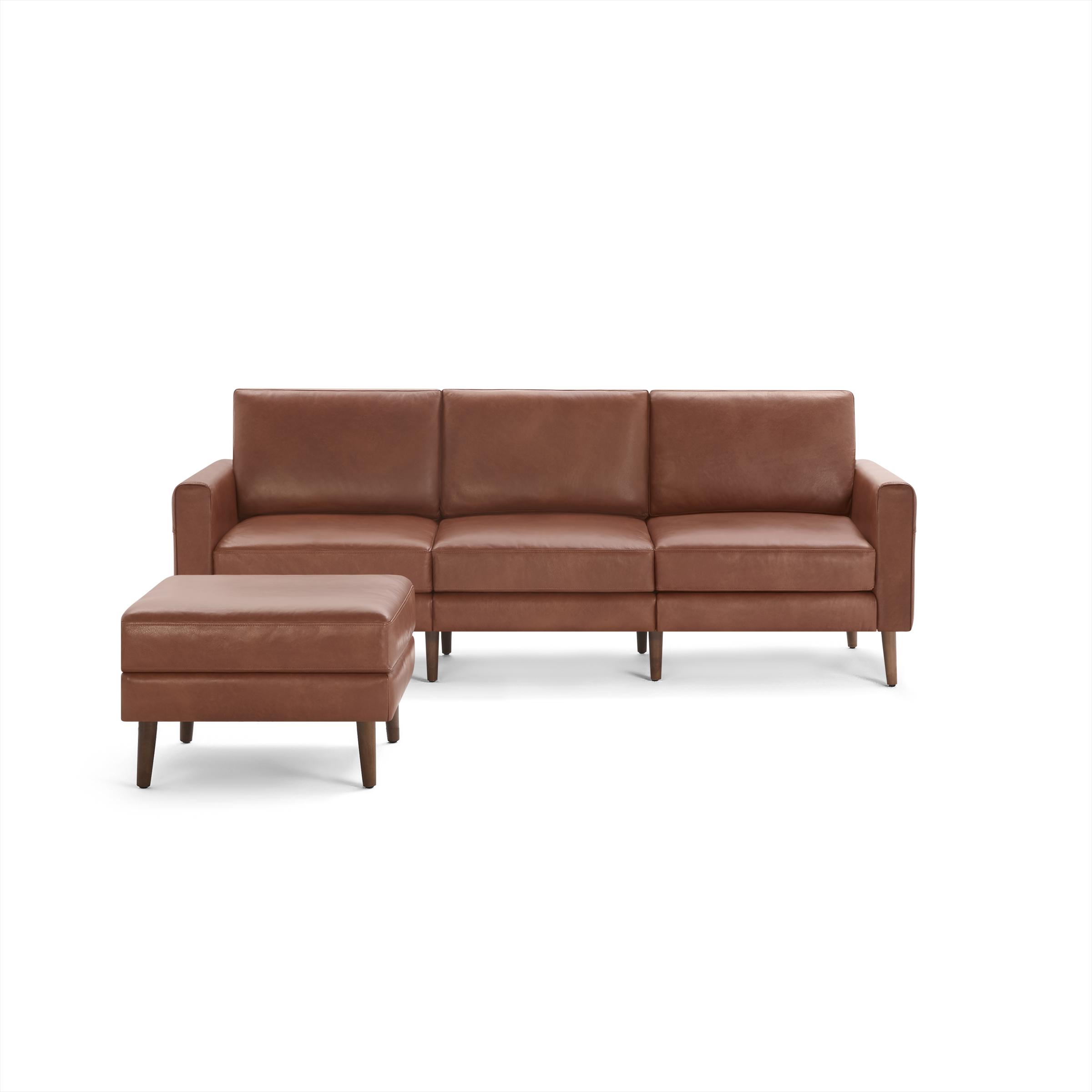 Modern three-seater brown leather sofa with matching ottoman, featuring wooden legs and clean, rectangular cushions.