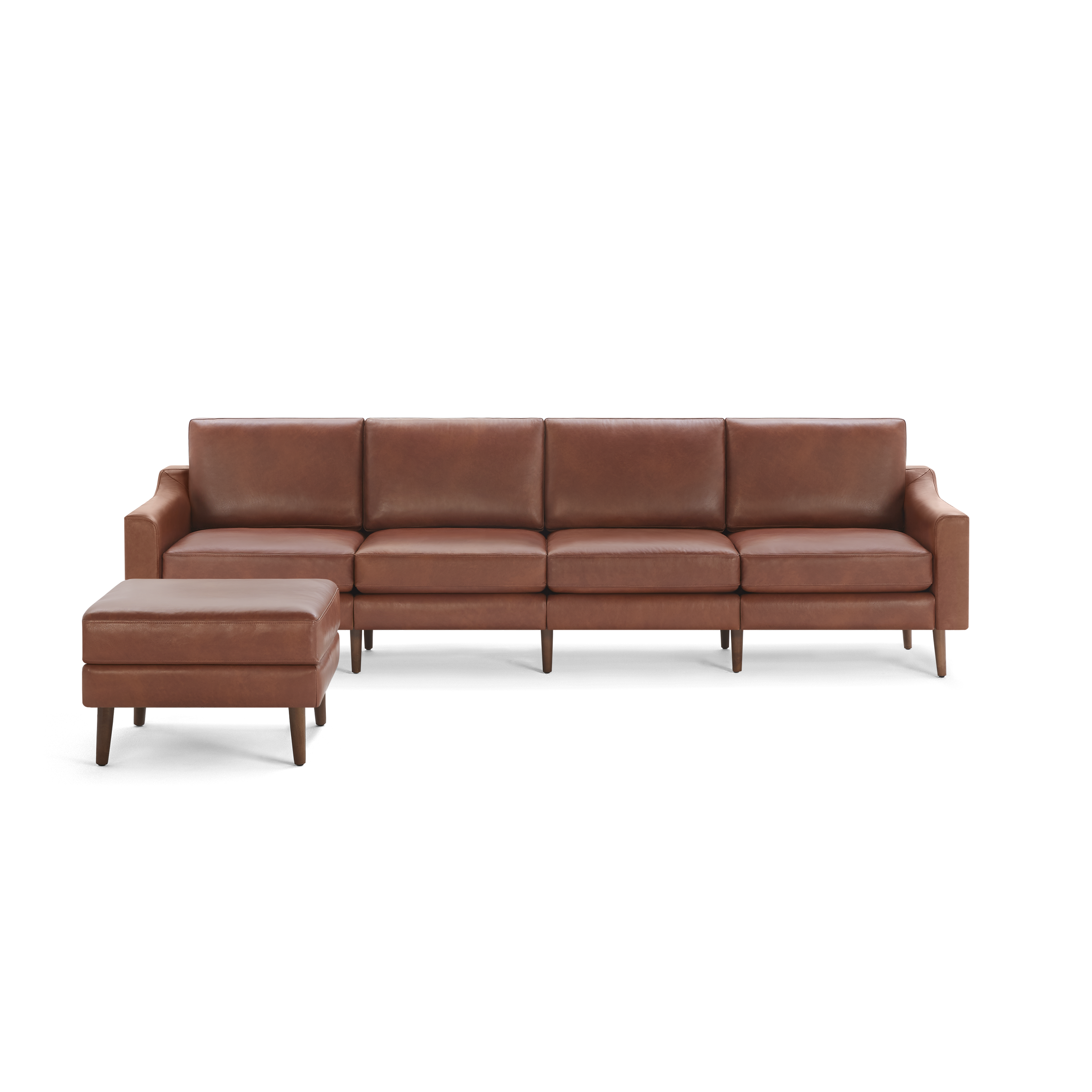 Brown leather sectional sofa with matching ottoman, featuring clean lines and wooden legs, isolated on black background.
