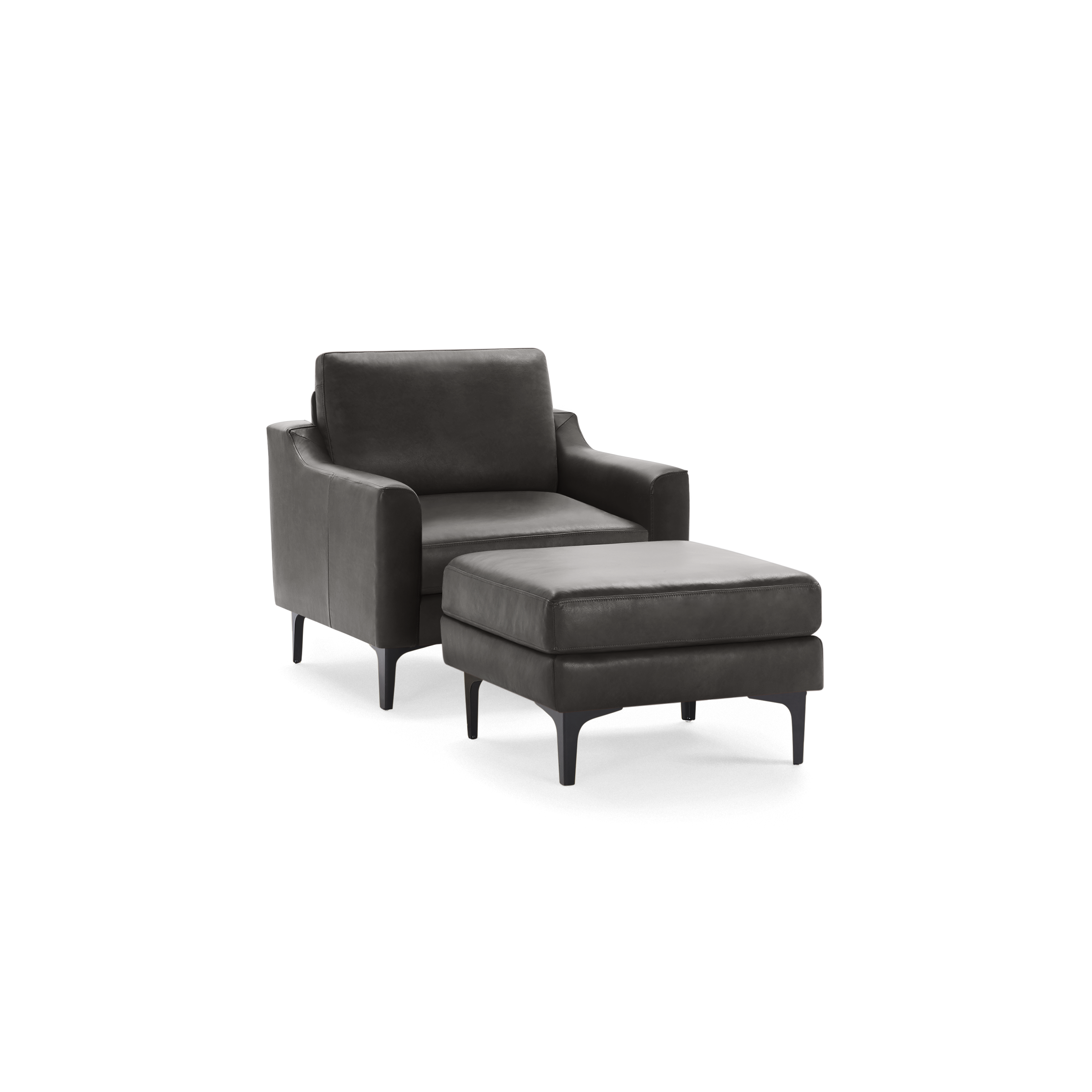 Modern dark gray leather armchair with matching cushioned ottoman, both supported by slim, black tapered legs.