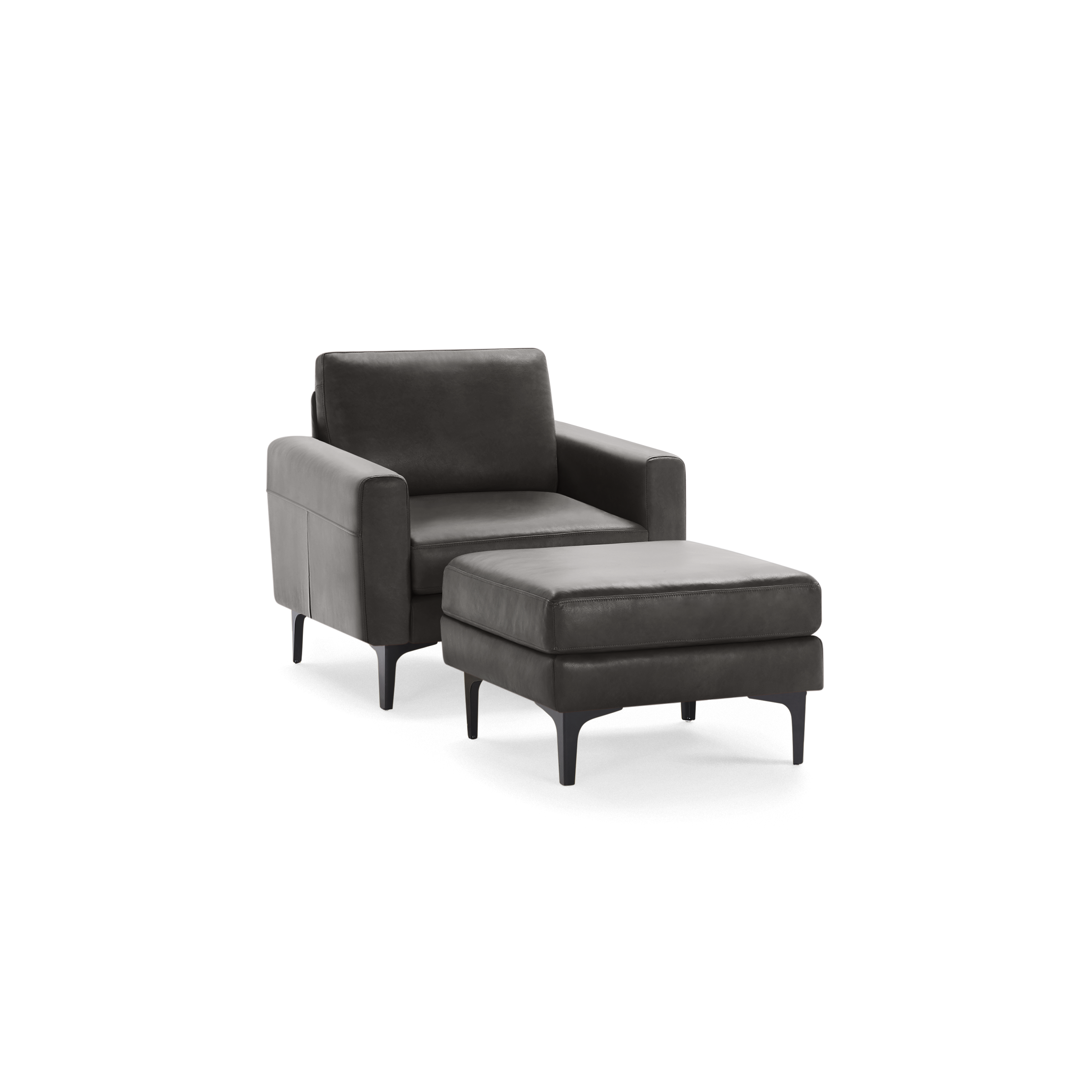 Modern dark gray leather armchair with matching ottoman, supported by sleek black legs for contemporary living spaces.