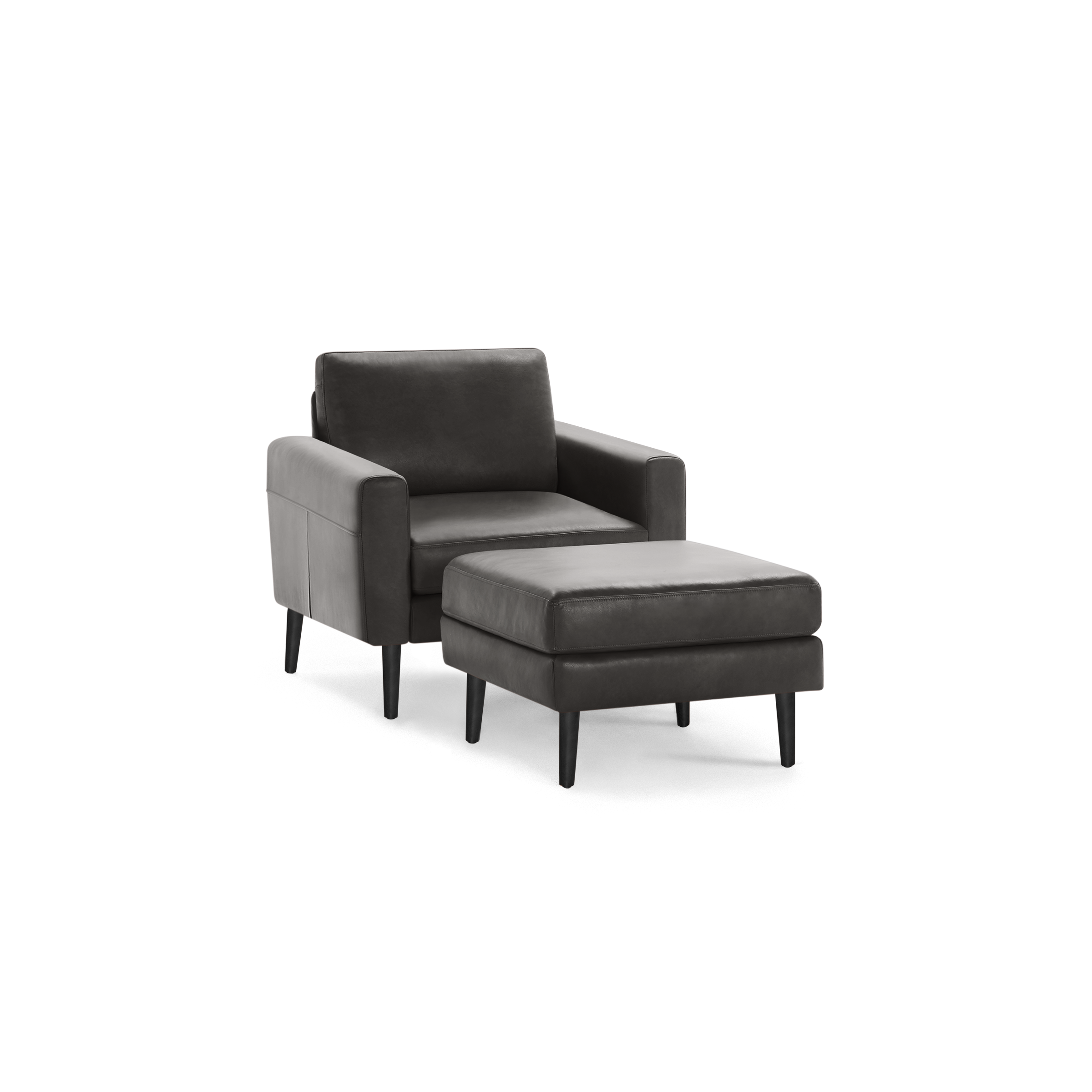 Dark gray leather armchair with matching ottoman, both featuring clean lines and black tapered legs.