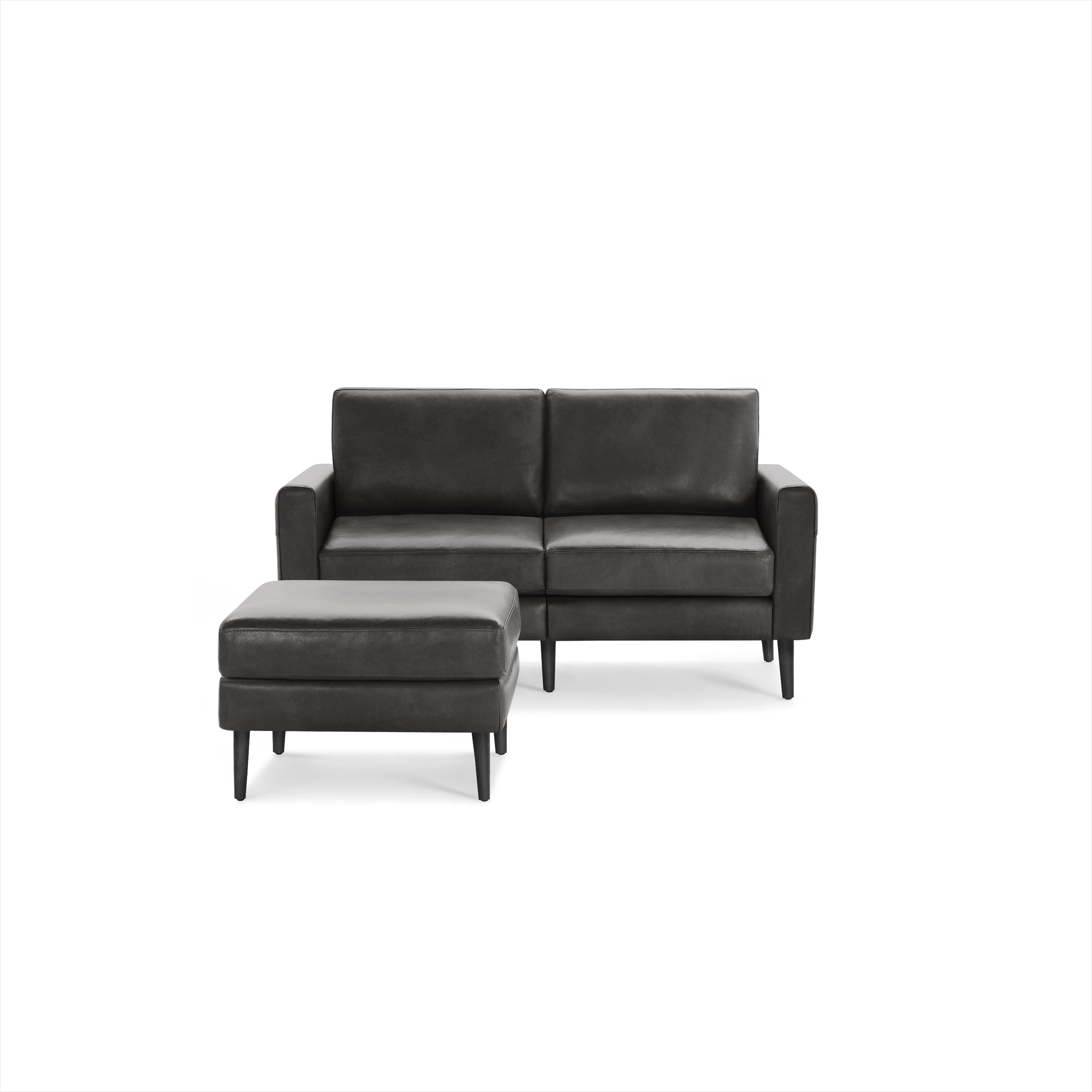 Dark gray modern leather loveseat with matching cushioned ottoman, featuring clean lines and tapered legs.