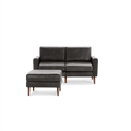 Dark gray leather two-seater sofa with matching ottoman, both featuring wooden legs and a modern, minimalist design.
