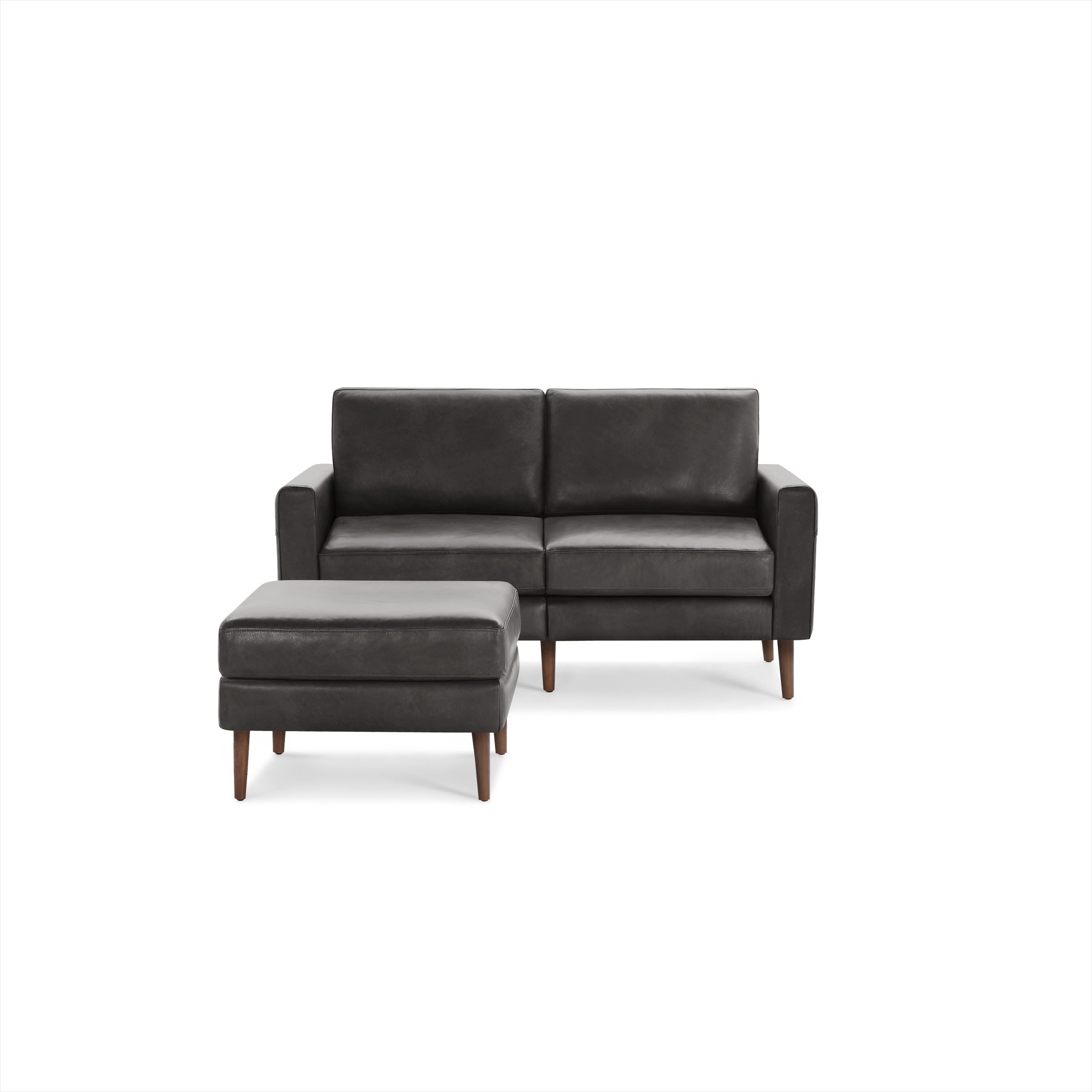 Dark gray leather two-seater sofa with matching ottoman, both featuring wooden legs and a modern, minimalist design.
