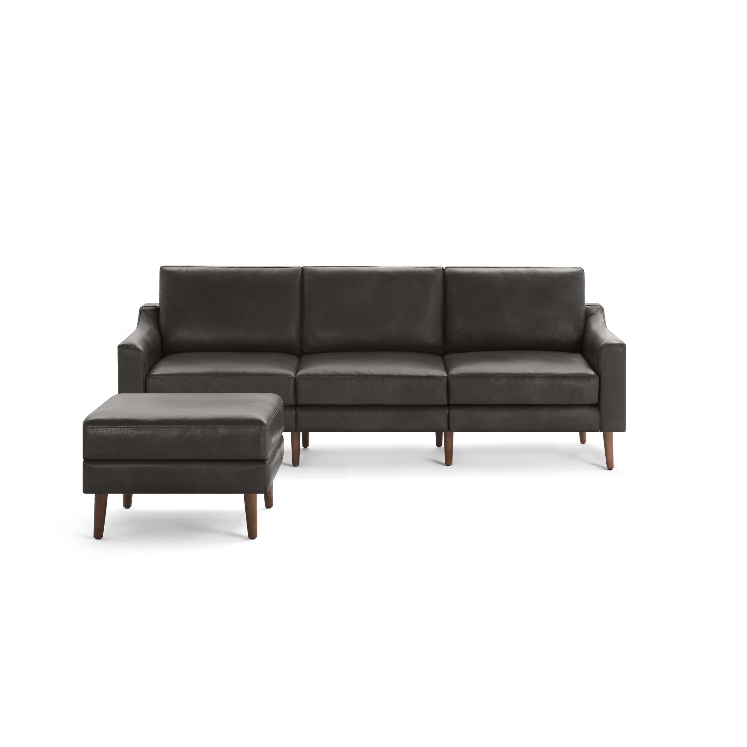 Modern dark gray leather sectional sofa with clean lines and matching ottoman, featuring wooden legs and cushioned seats.