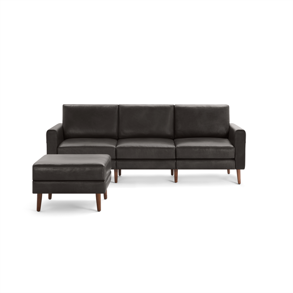 Dark brown leather three-seater sofa with a matching ottoman, featuring wooden legs and clean, modern design.
