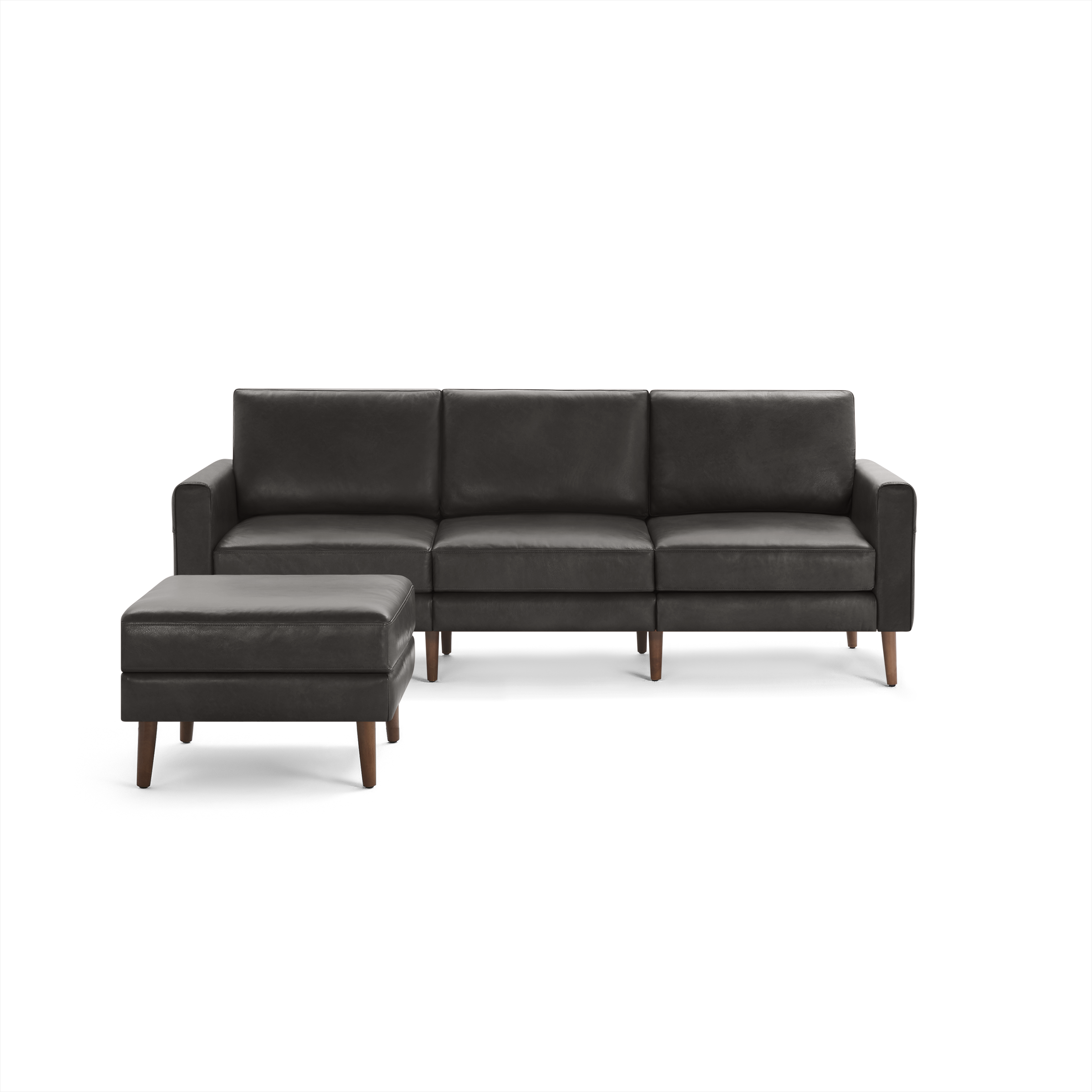 Dark brown leather three-seater sofa with a matching ottoman, featuring wooden legs and clean, modern design.