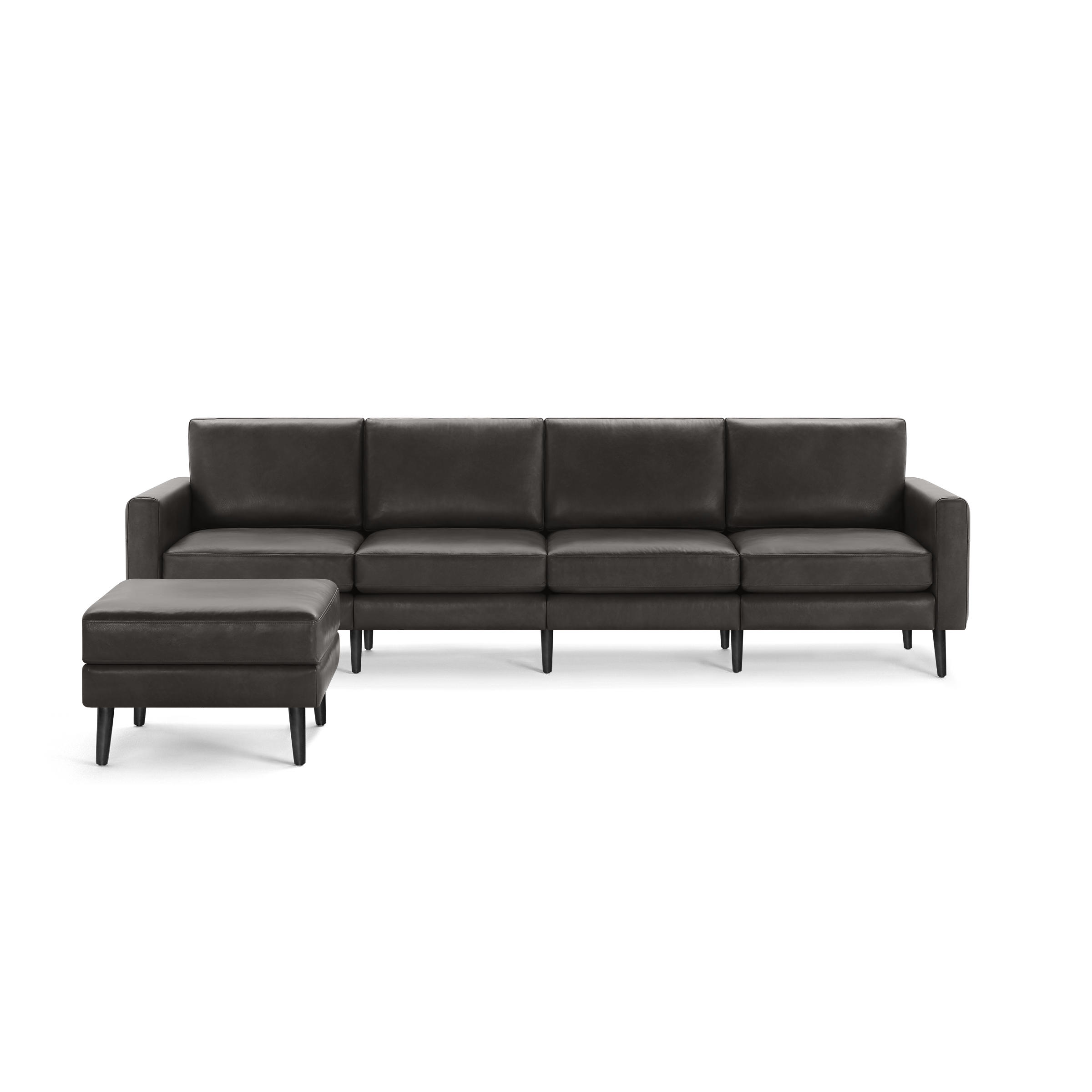 Dark gray modern leather sectional sofa with separate matching ottoman and wooden legs, clean lines and cushioned seats and backs.
