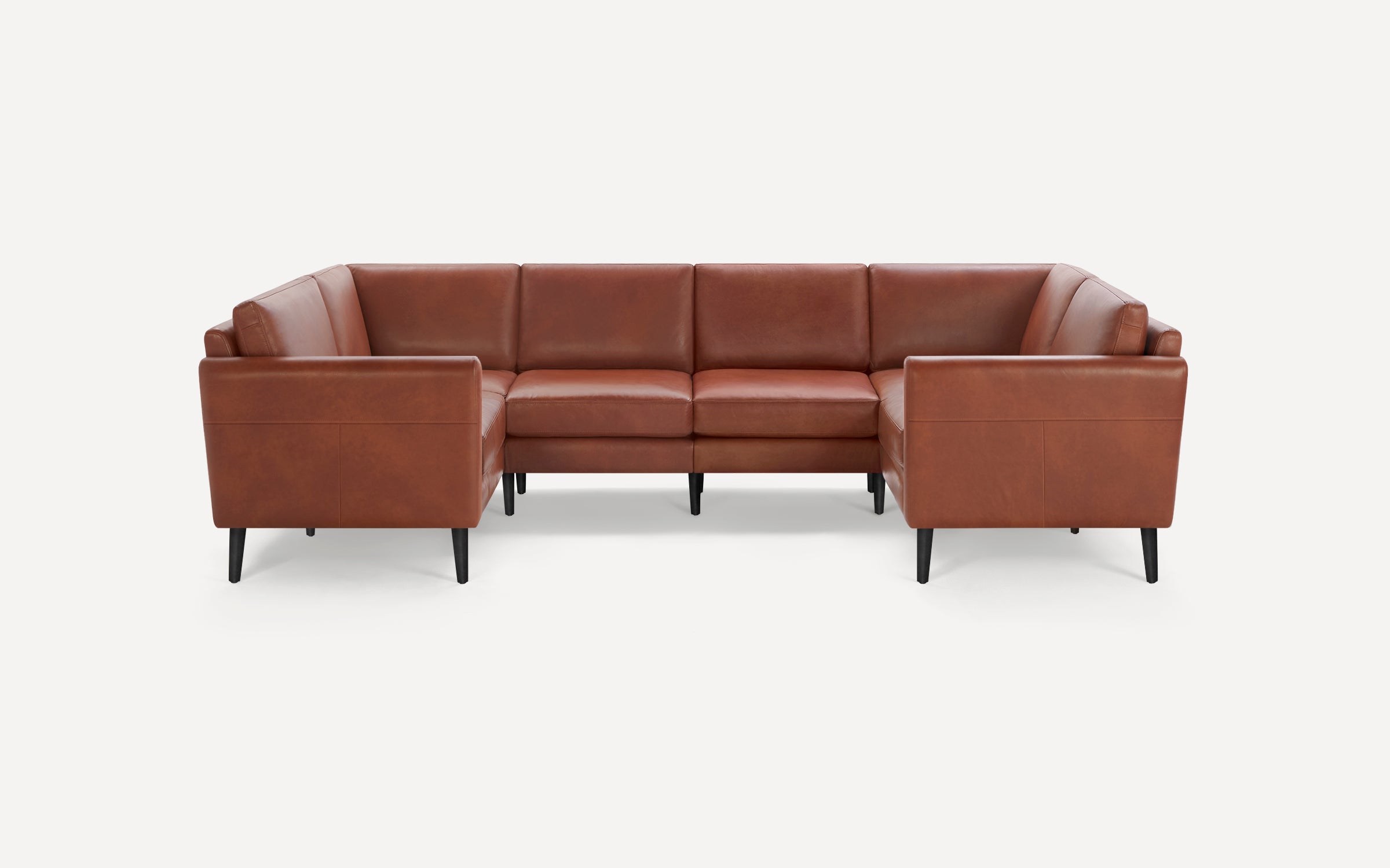 Brown leather U-shaped sectional sofa with clean lines, tufted cushions, and black tapered legs on a white background.