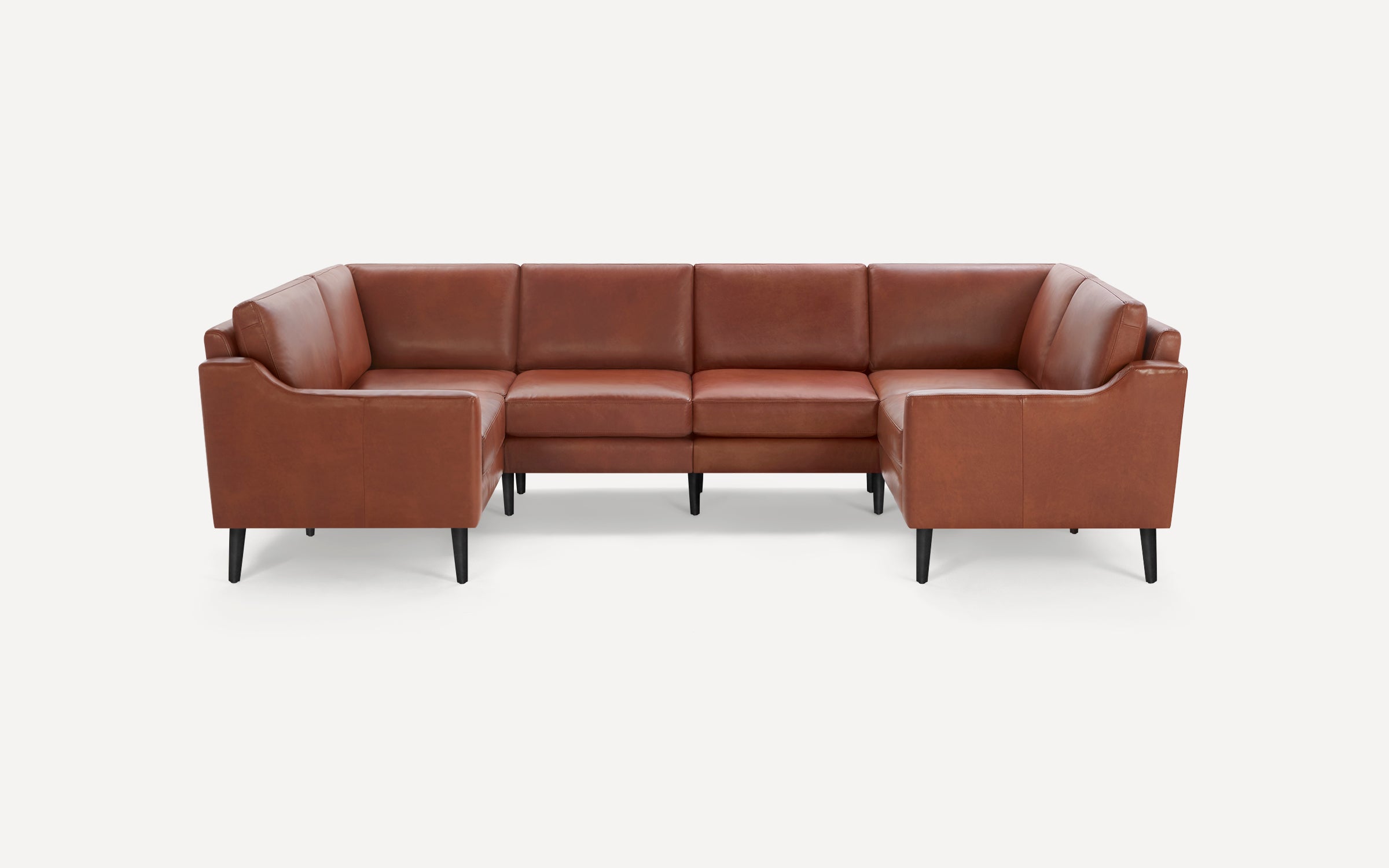 Modern mid-century style brown leather sectional sofa with clean lines and black tapered wood legs on white background.