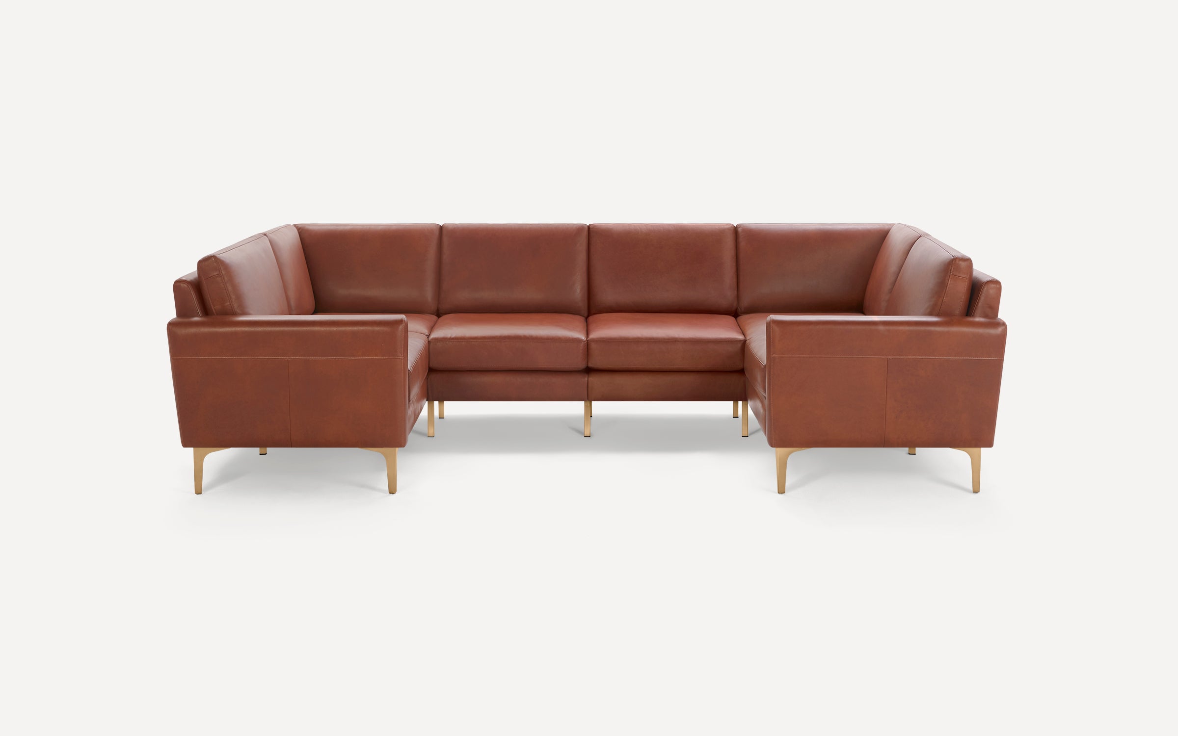 Brown leather sectional sofa with clean lines, cushioned seats, and slender gold metal legs, set against a white background.