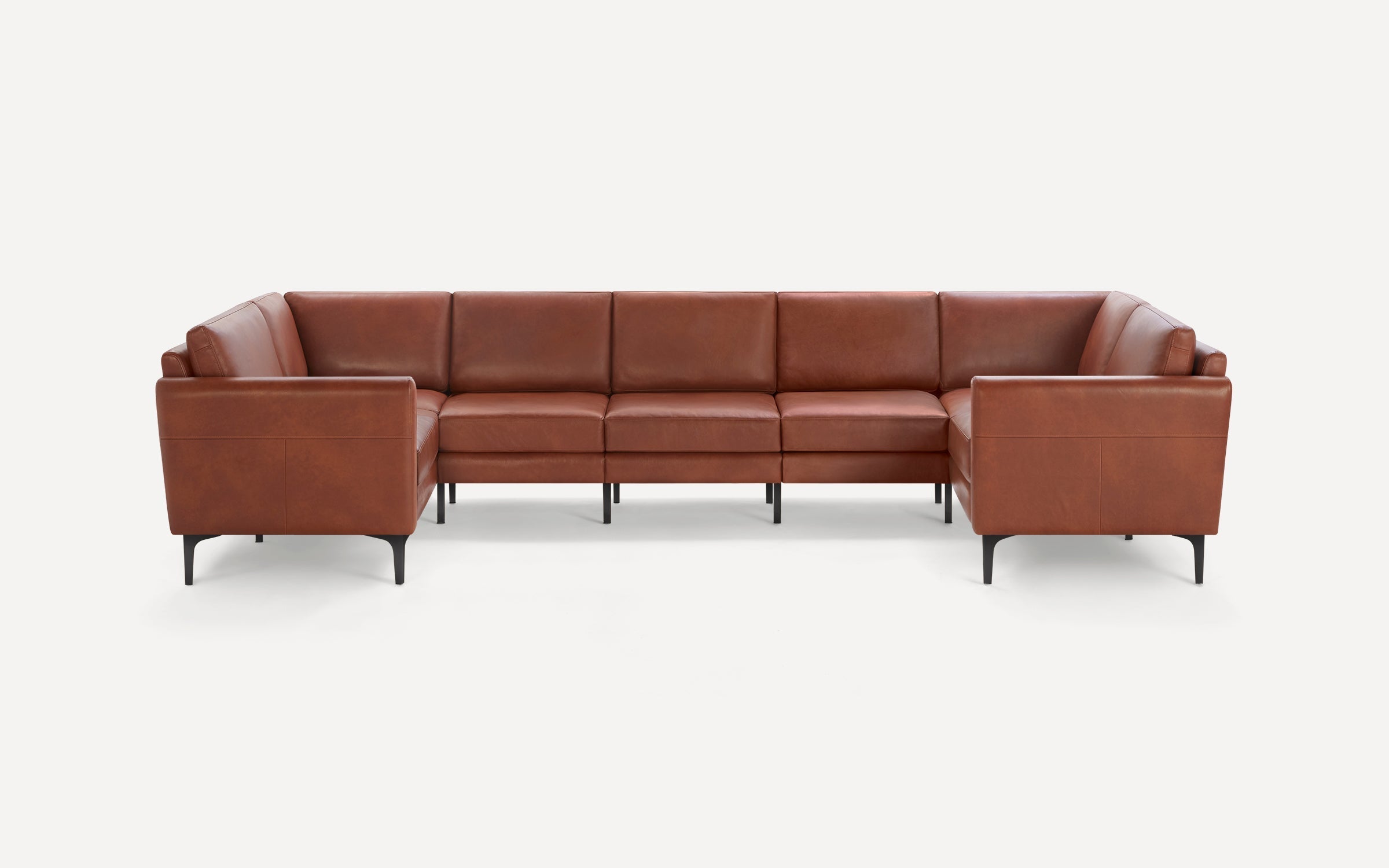 Brown leather sectional sofa with black legs, featuring clean lines and modern design against a white background.