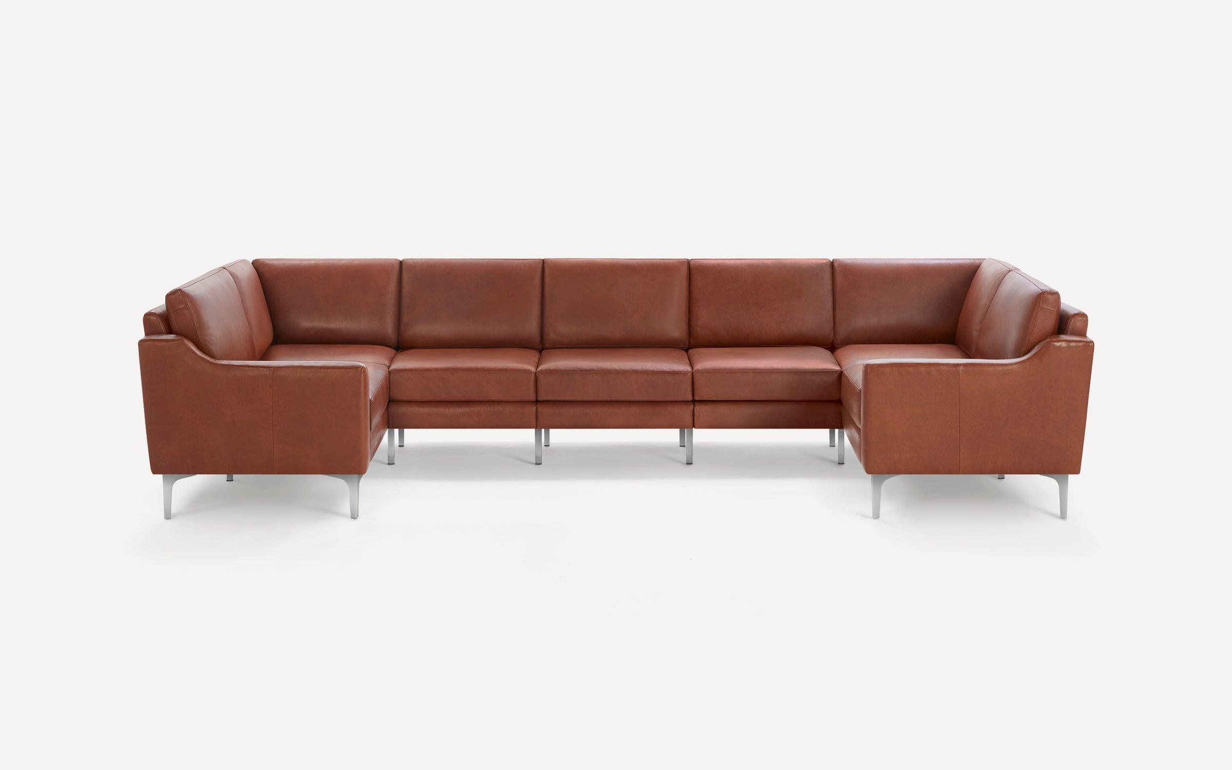 Large modern U-shaped sectional sofa in brown leather with metal legs, featuring clean lines and cushioned seats.