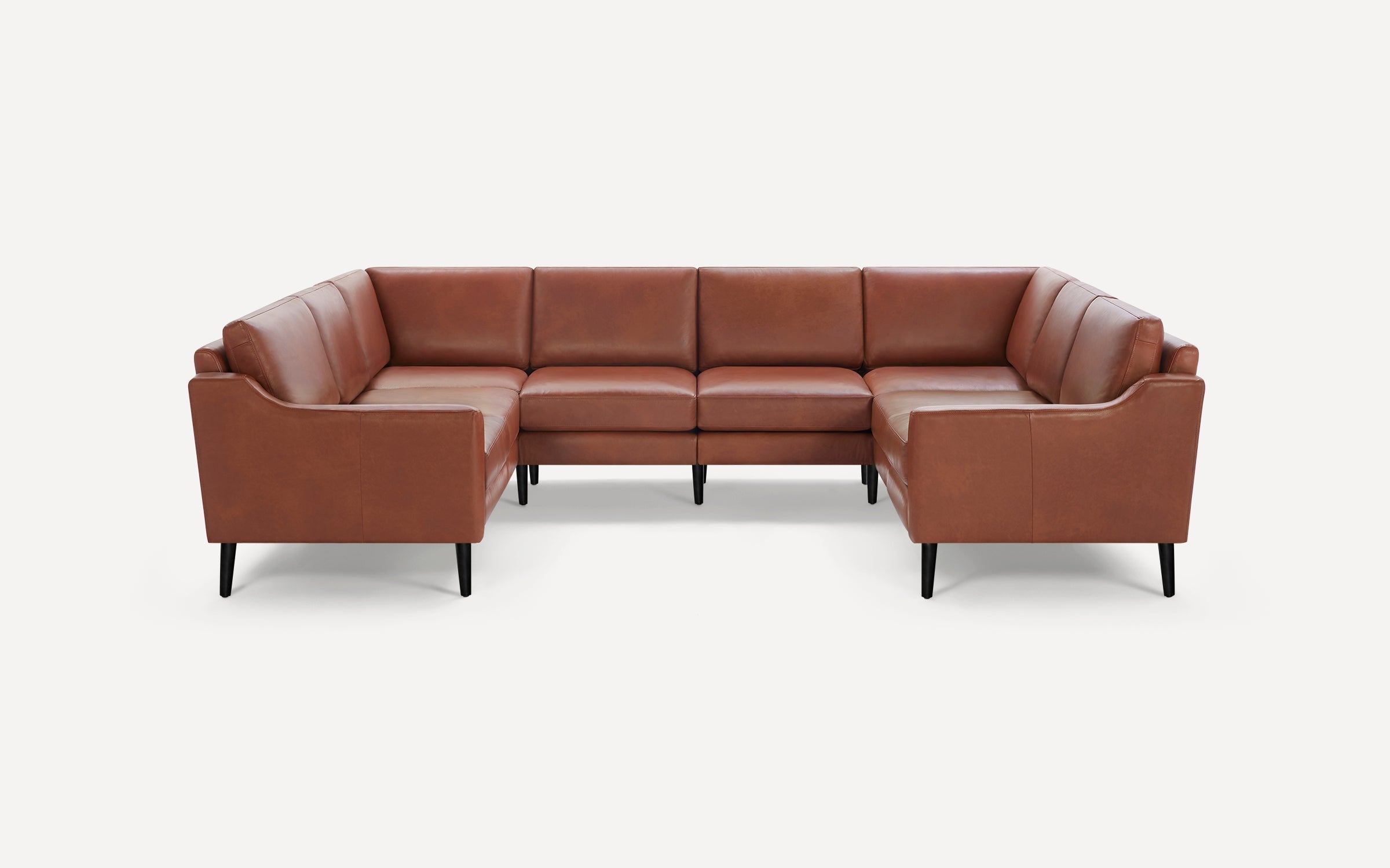 Modern U-shaped sectional sofa with brown leather upholstery and slim black wooden legs, designed for spacious seating.