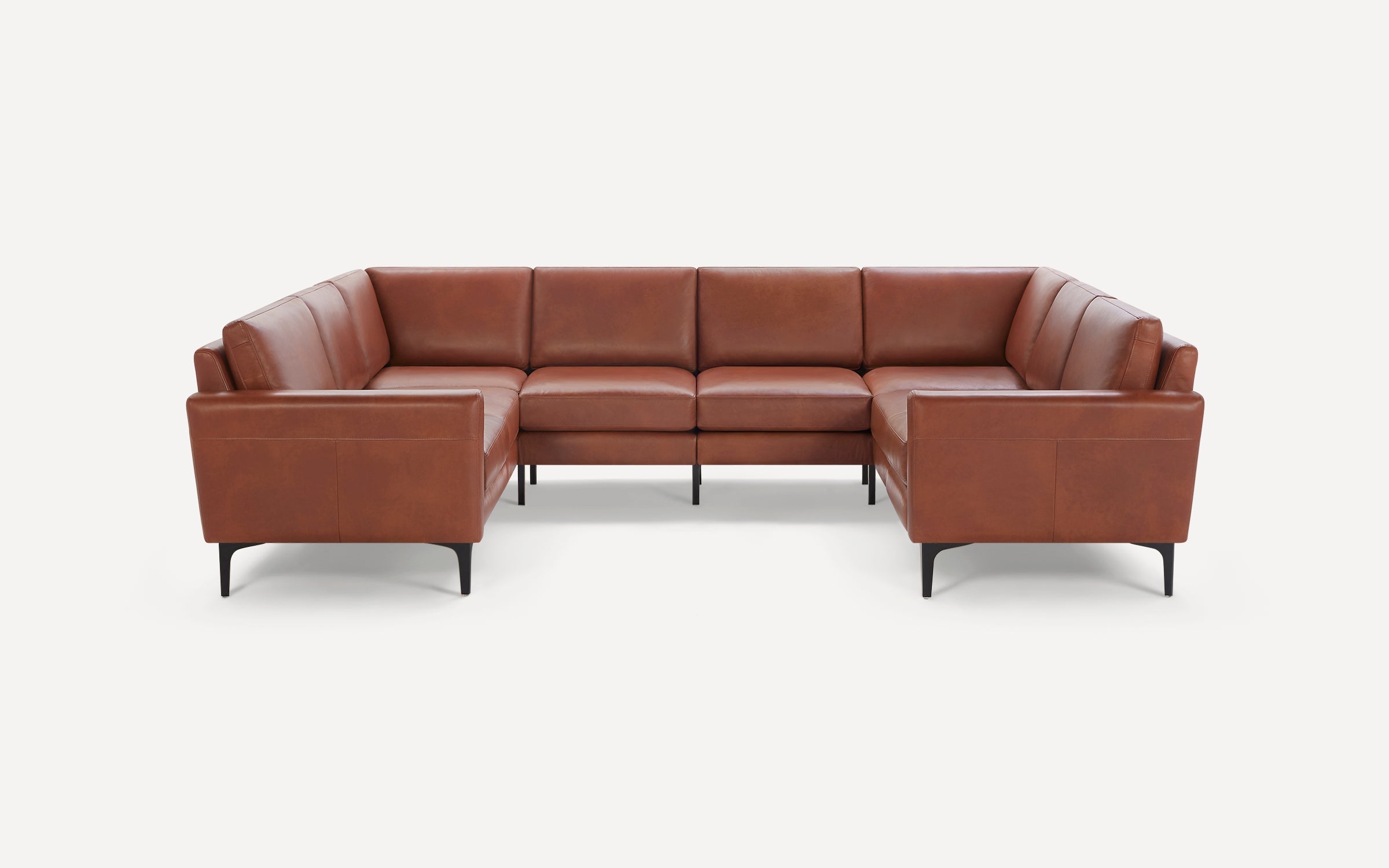 Modern U-shaped sectional sofa upholstered in smooth brown leather with slim black metal legs.