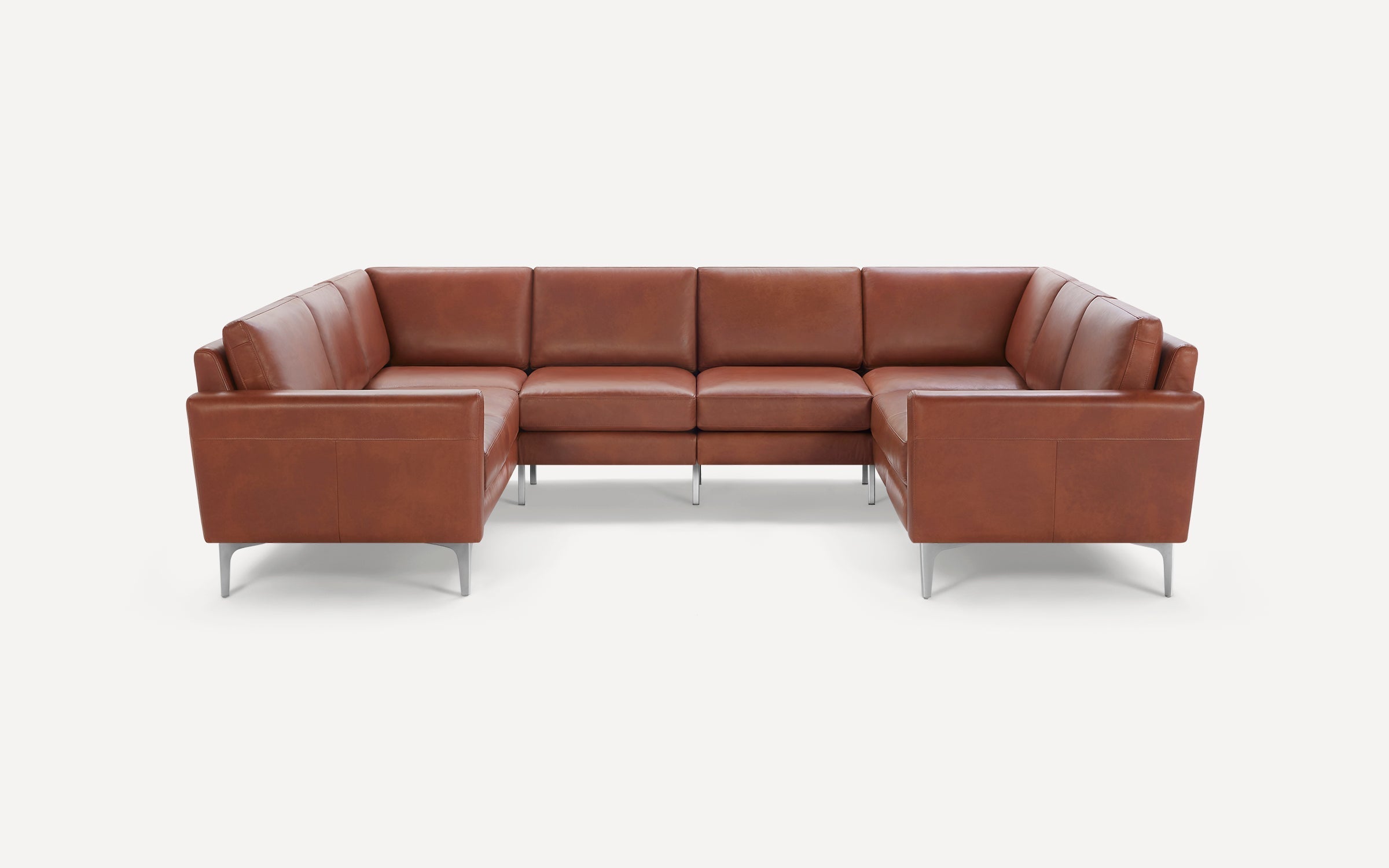 Brown leather L-shaped sectional sofa with metal legs and clean, modern design on a white background.