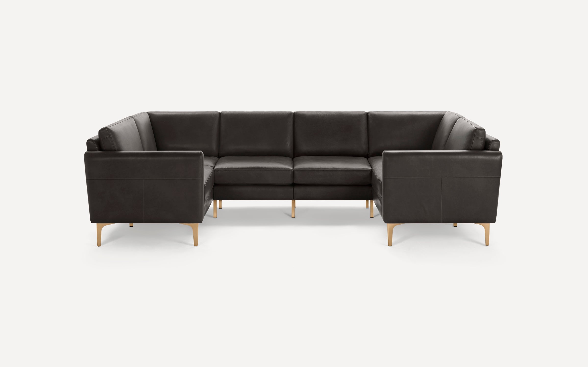 Modern L-shaped sectional sofa with dark leather upholstery and light wooden legs, featuring clean lines and plush cushions.