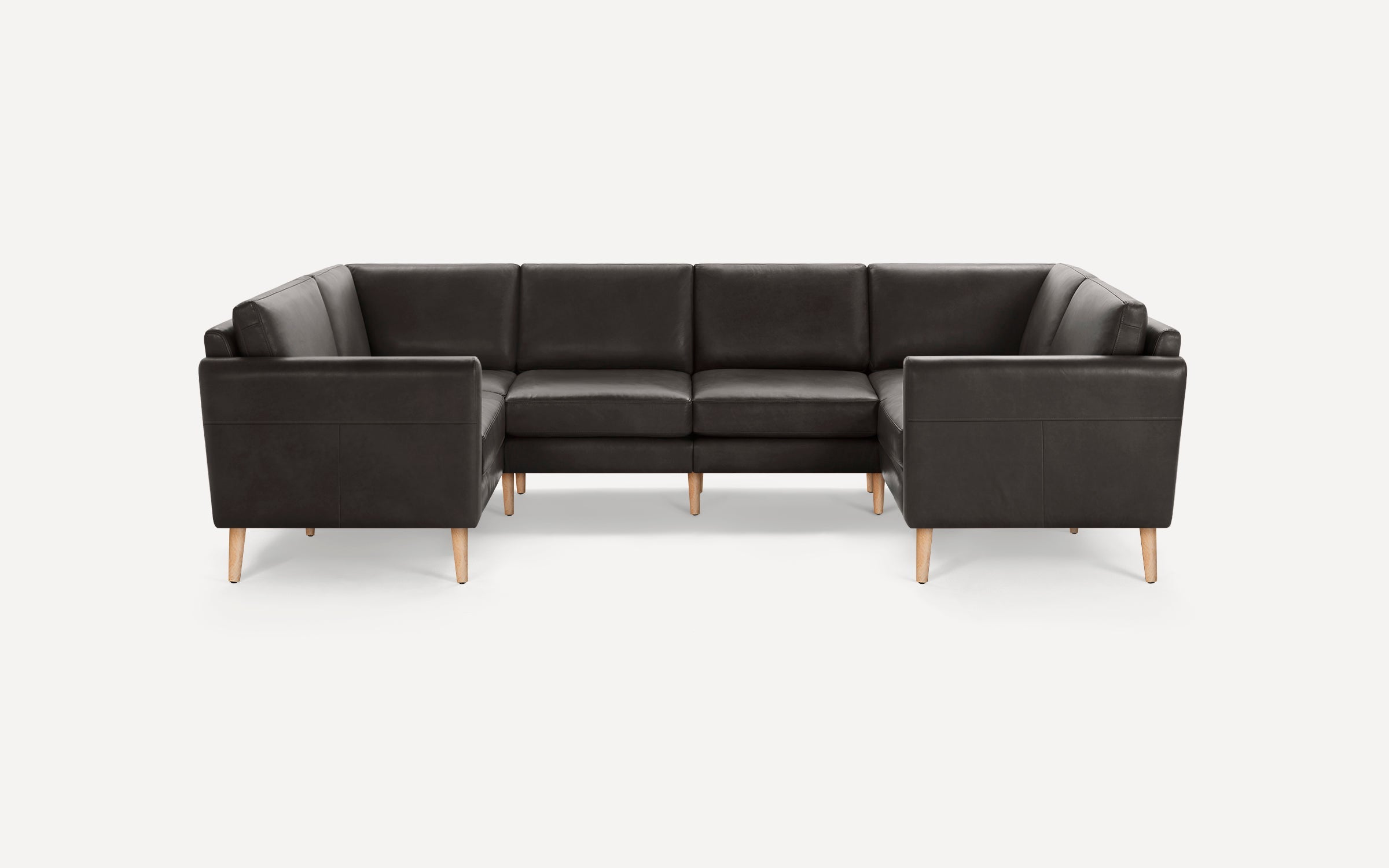 Dark brown leather sectional sofa with clean lines and light wooden legs, arranged in a U-shape.