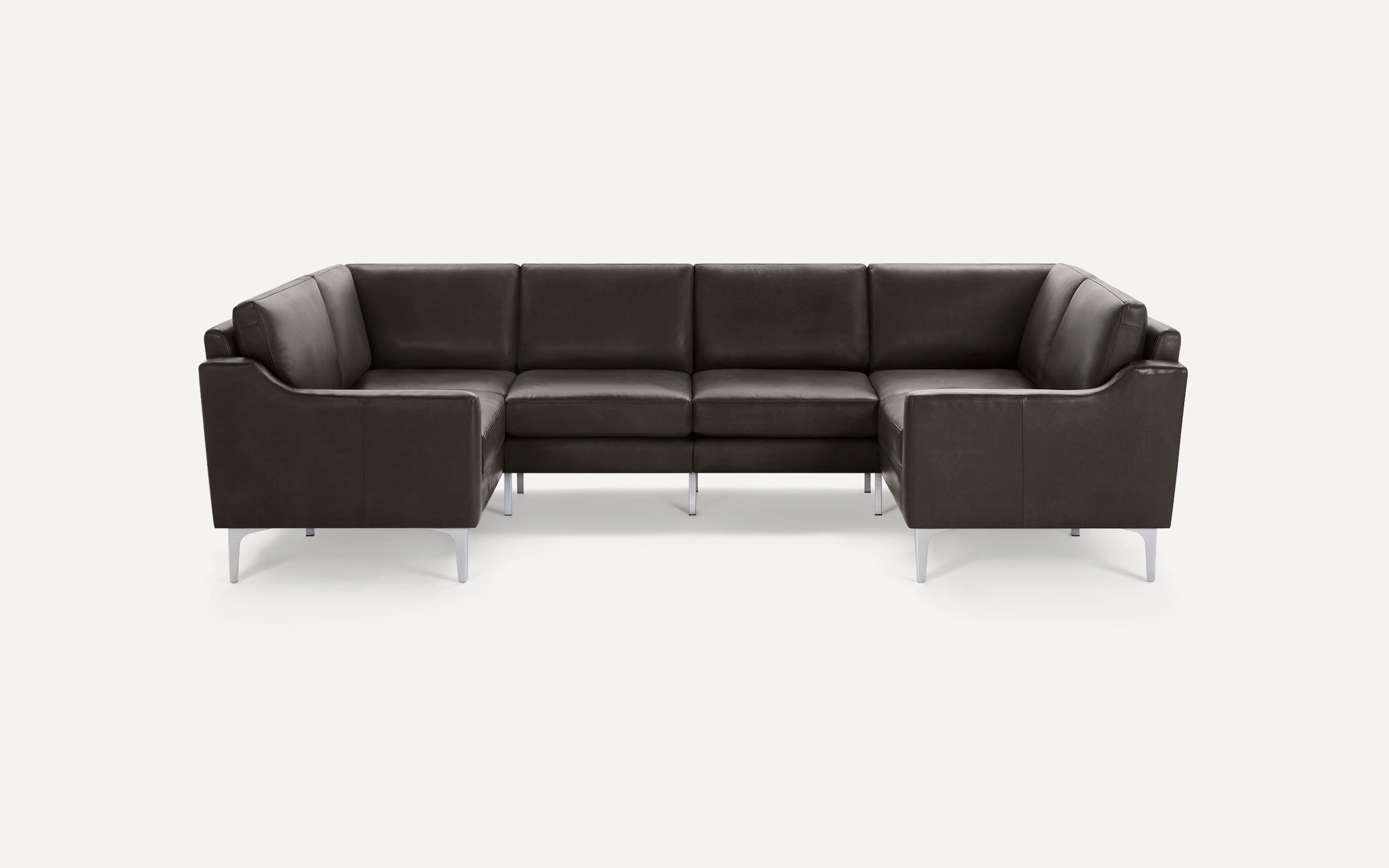 Modern dark gray leather U-shaped sectional sofa with metal legs on a plain white background.