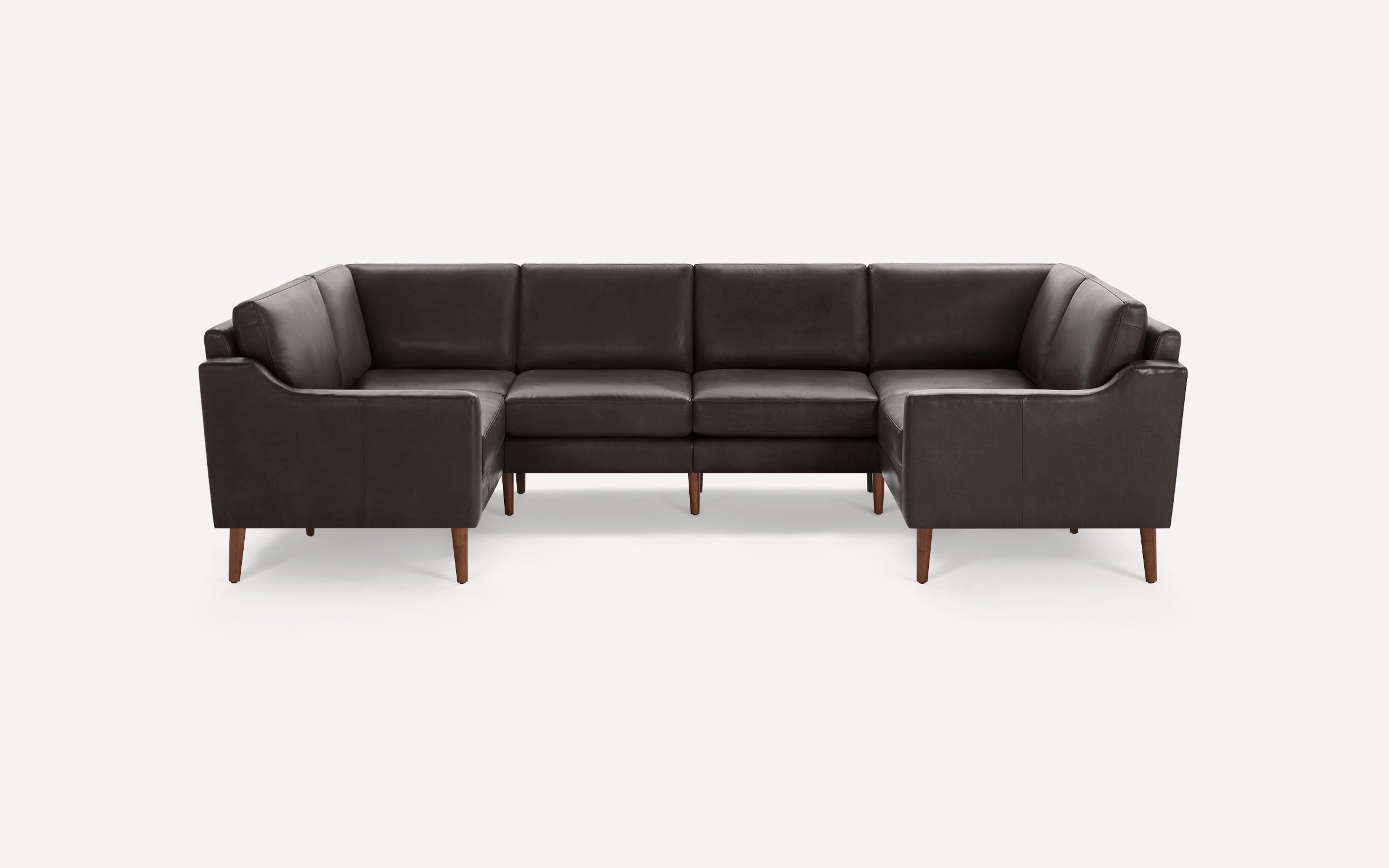 Dark gray sectional sofa with clean lines, wooden tapered legs, and cushioned seats and backs, shown on white background.