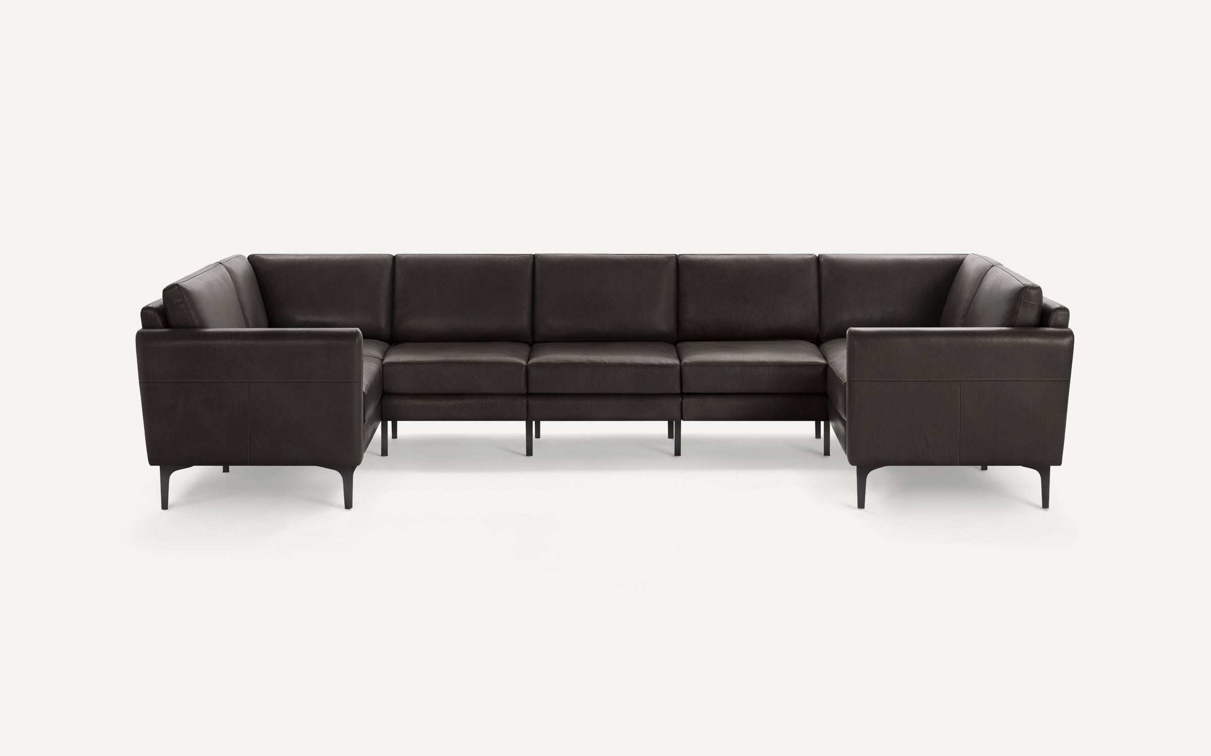 Large modern black leather sectional sofa with clean lines and slim metal legs, arranged in a U-shape.