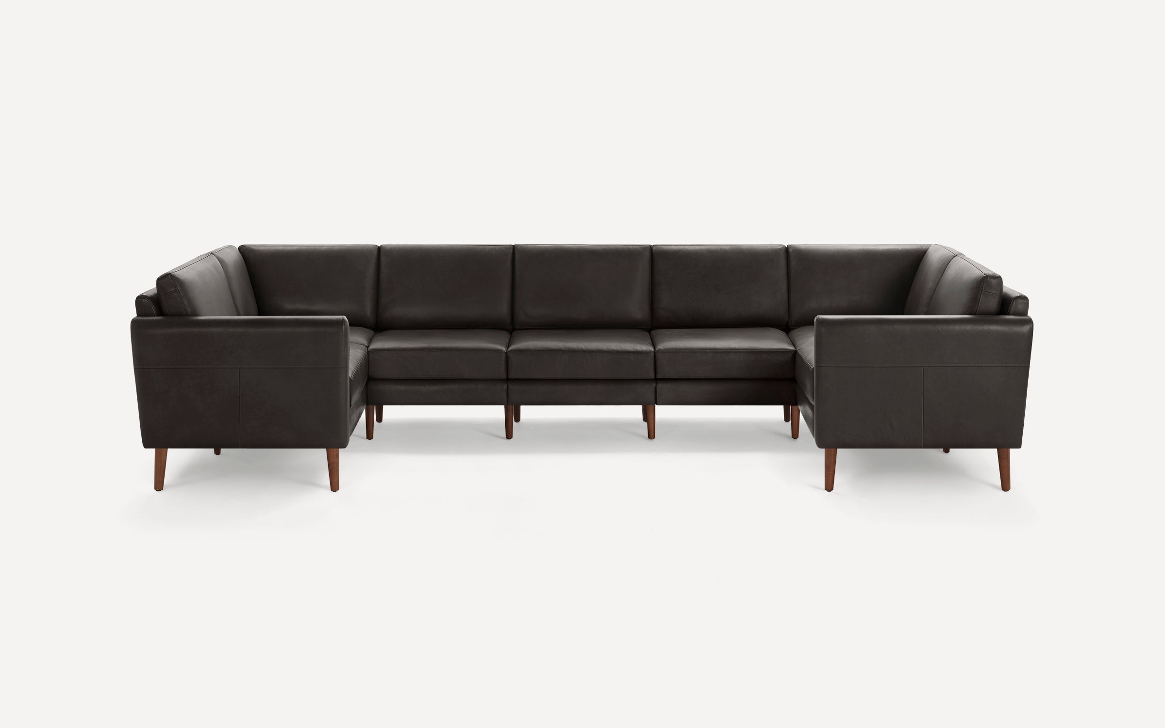 Modern dark brown leather U-shaped sectional sofa with wooden tapered legs, featuring clean lines and plush cushioning.