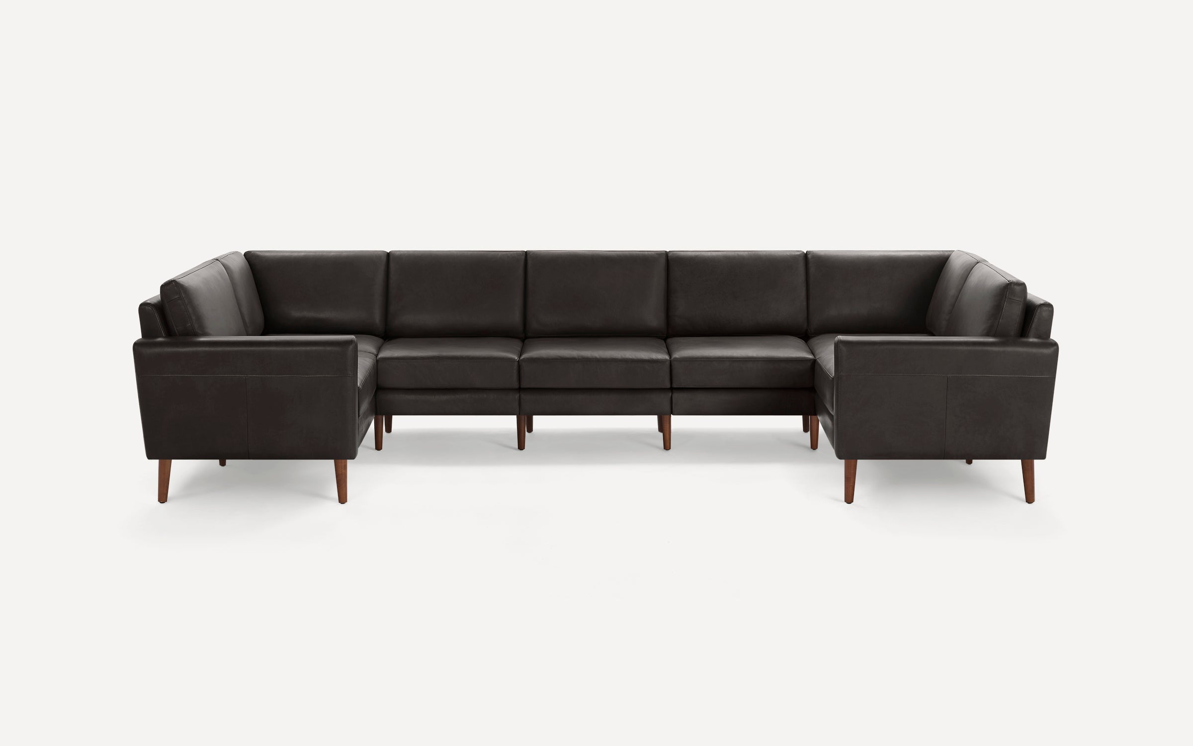 Dark brown leather sectional sofa with clean lines, wooden legs, and cushioned seats and backs, set against a white background.