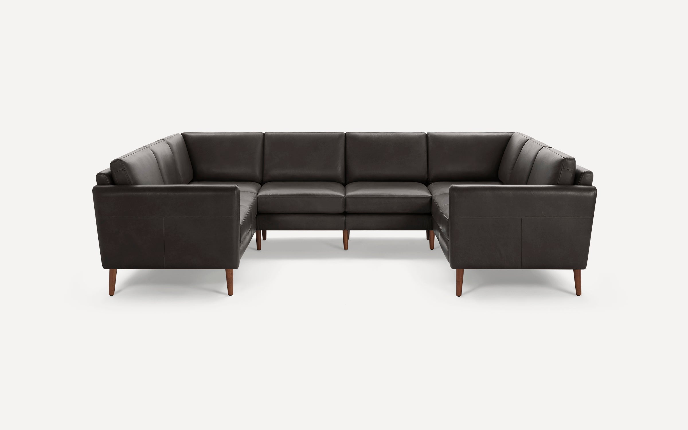 Dark brown leather U-shaped sectional sofa with wooden tapered legs, clean lines, and plush cushions against a white background.