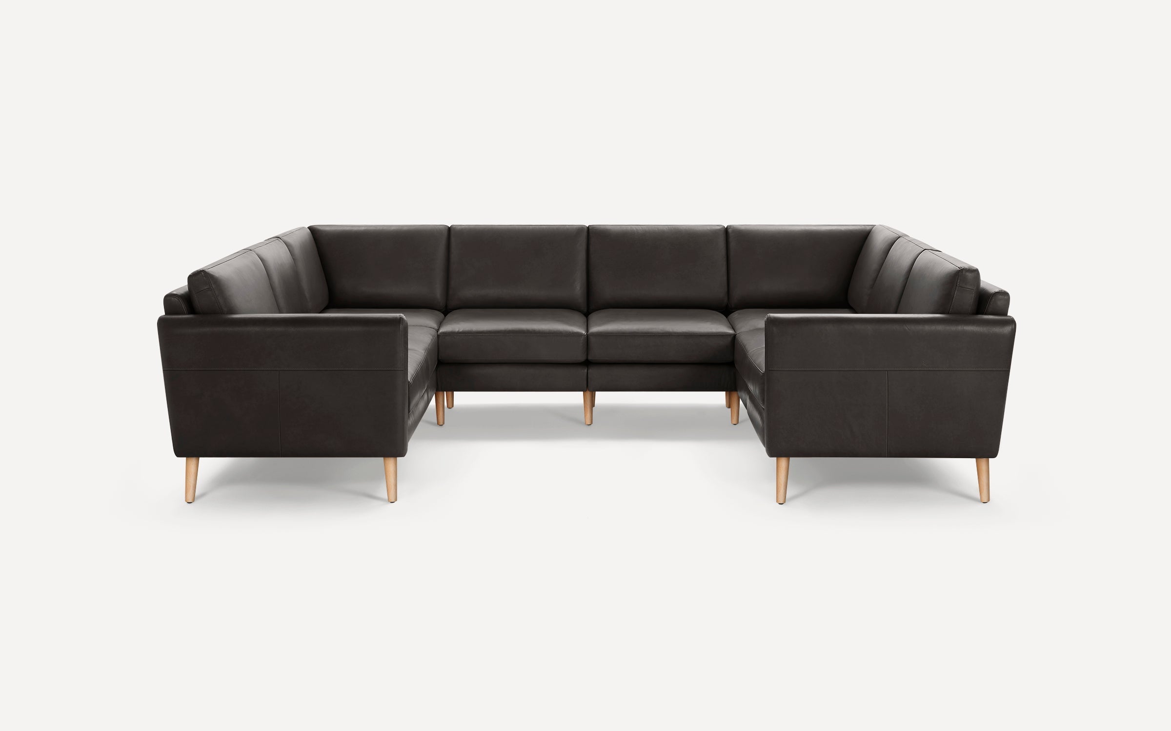 Dark brown leather U-shaped sectional sofa with wooden legs, featuring clean lines and modern design.